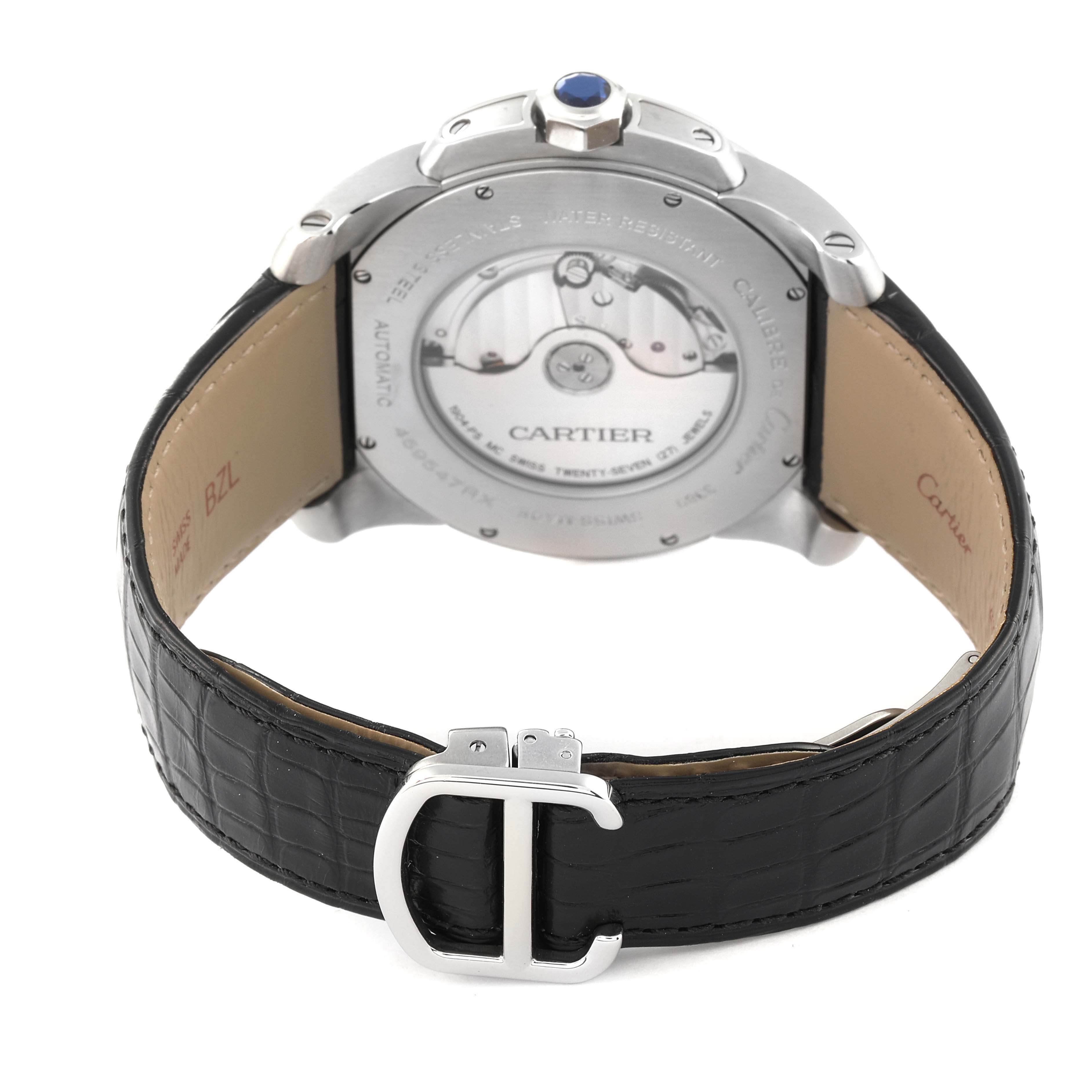 The image shows the back view of a Calibre de Cartier watch by Cartier, highlighting the movement mechanism and black leather strap.