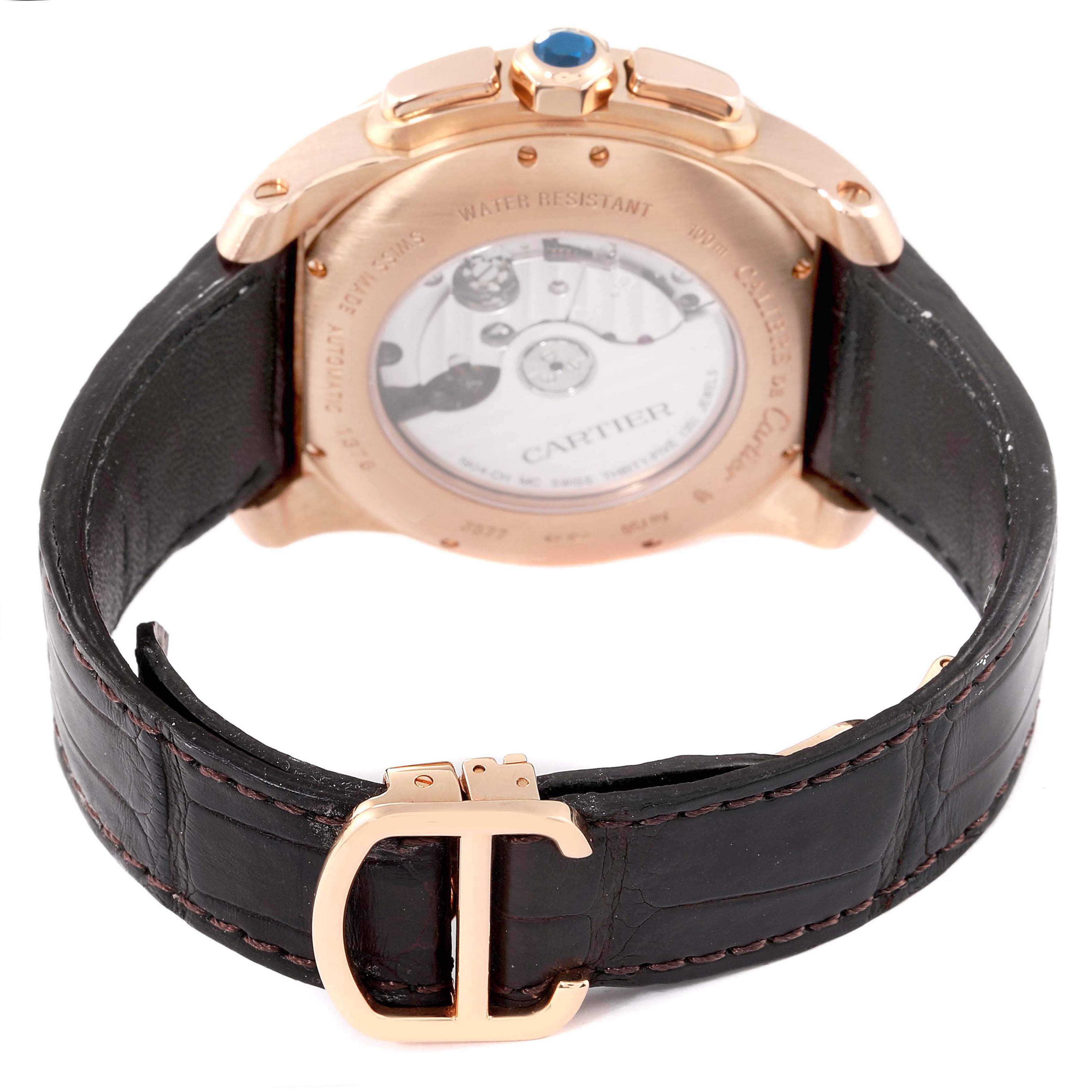 The image shows the back view of a Calibre de Cartier watch, highlighting the case back, strap, and buckle.