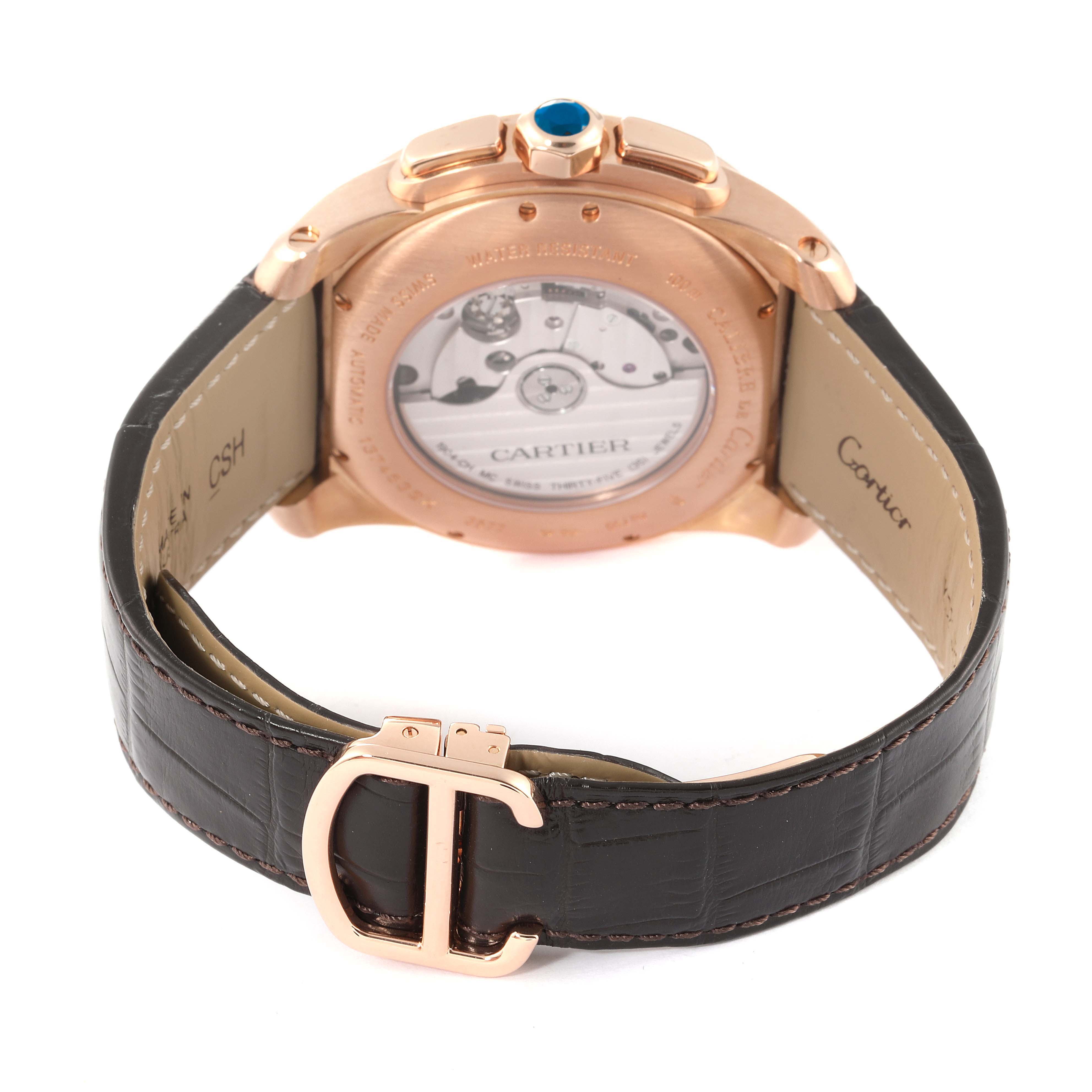 The image shows the back view of the Calibre de Cartier watch by Cartier, highlighting the case back, strap, and clasp.