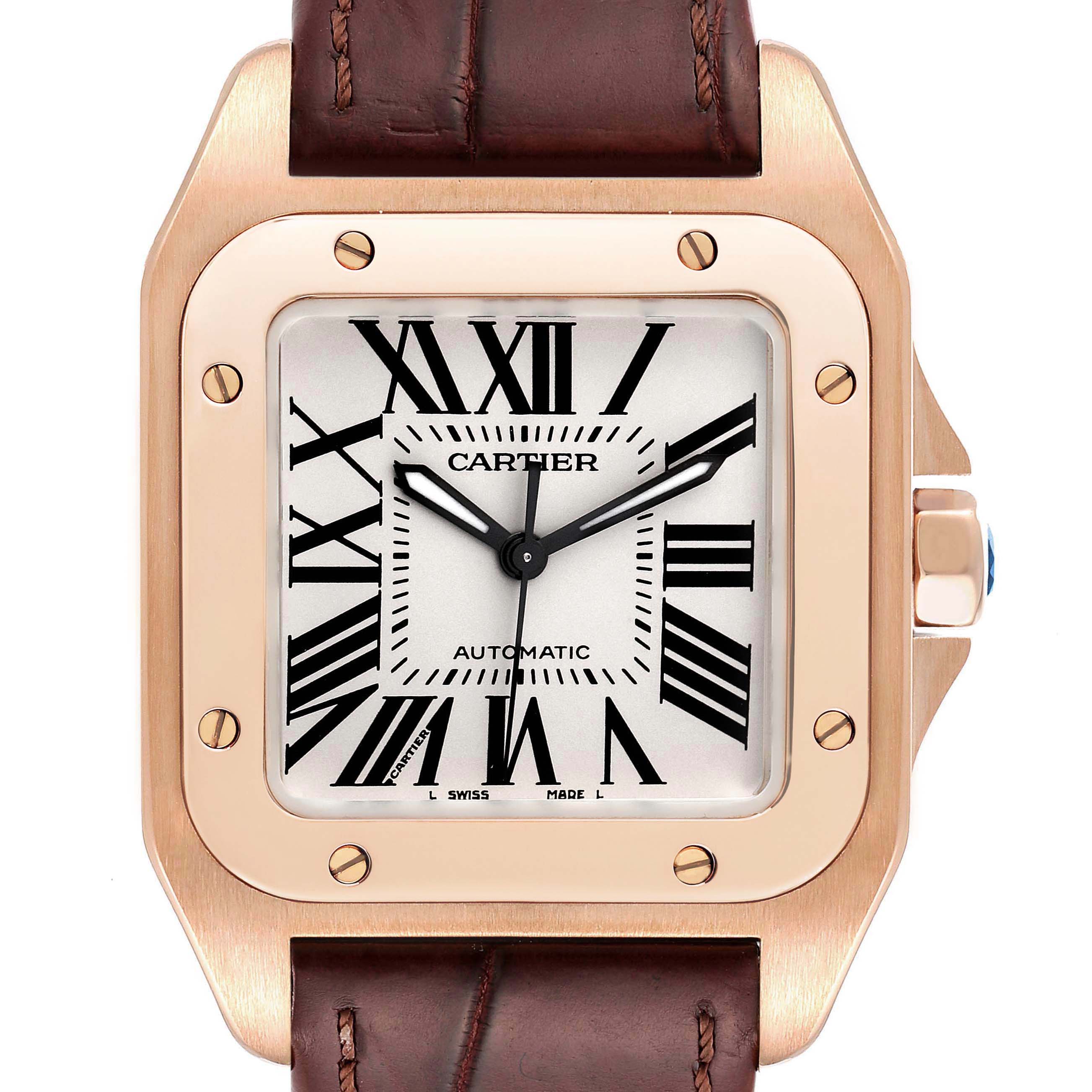 The image shows a close-up of a Cartier Santos W20108Y1 Men's Rose Gold Silver Dial W20108Y1 Men's Rose Gold Silver Dial watch face, highlighting its case, dial, hands, and leather strap.