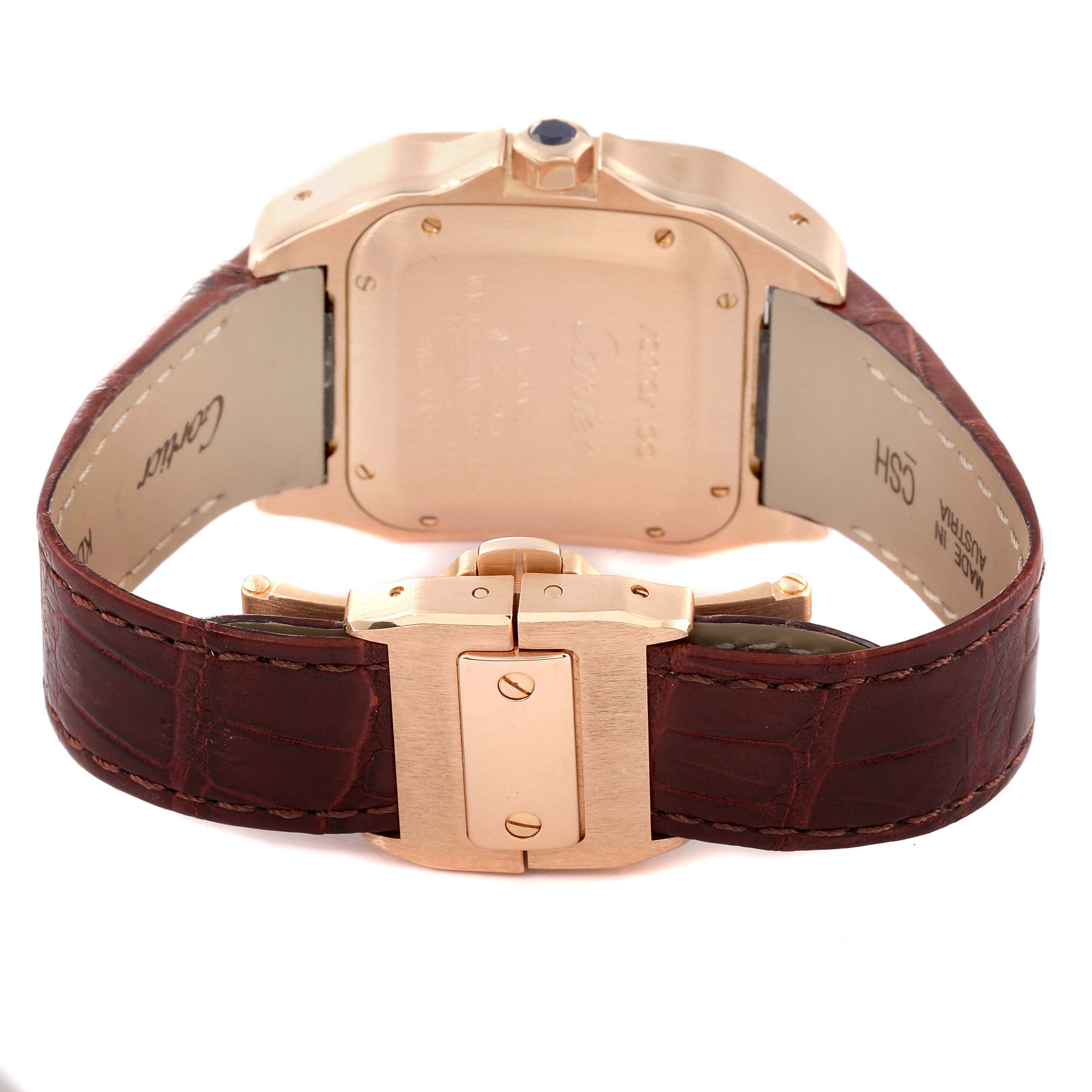 The image shows the back view of a Santos model Cartier watch, highlighting its case, clasp, and brown leather strap.