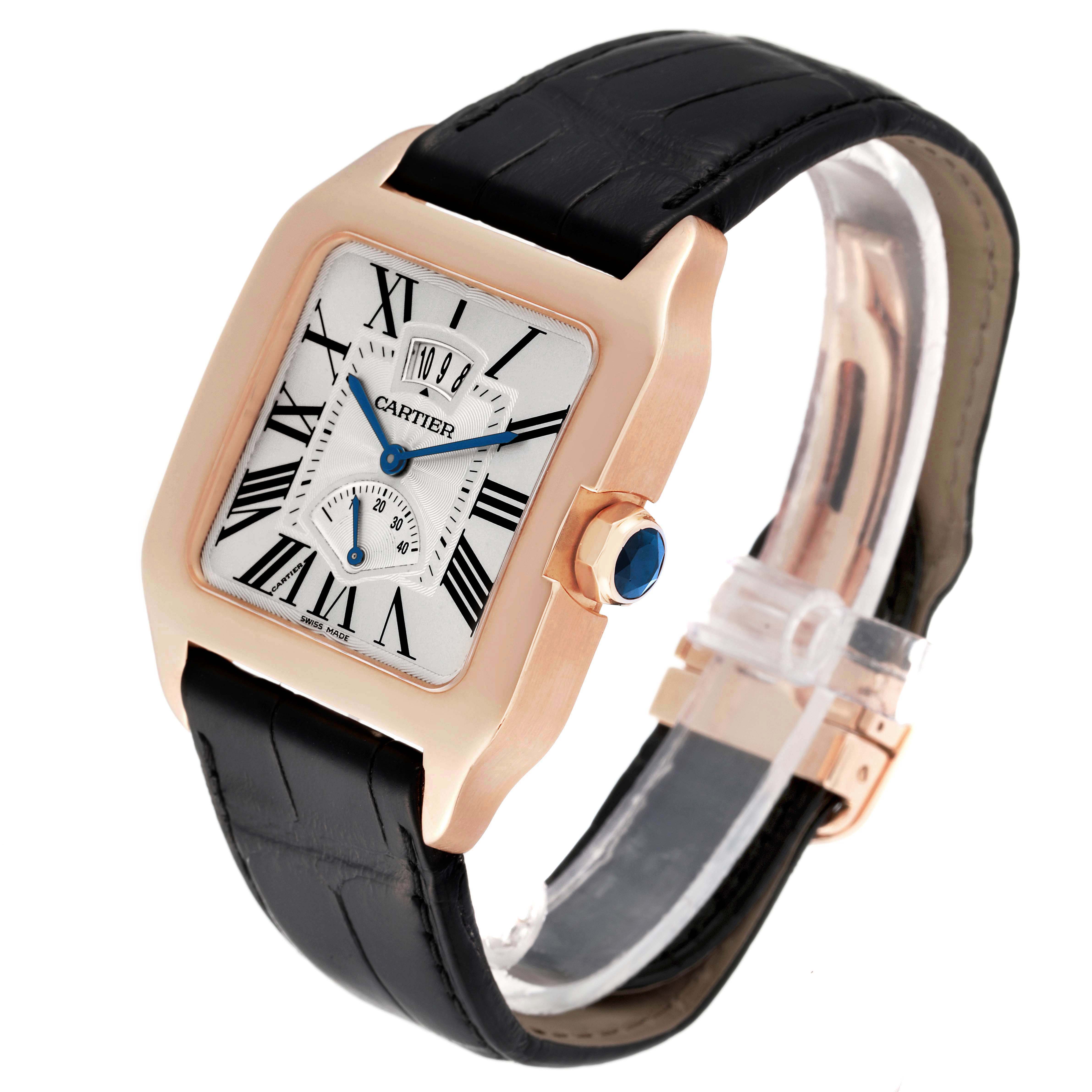 The Cartier Santos Dumont W2020067 Men's Rose Gold Silver Dial W2020067 Men's Rose Gold Silver Dial watch is shown at an oblique angle, displaying its face, crown, and part of the strap.