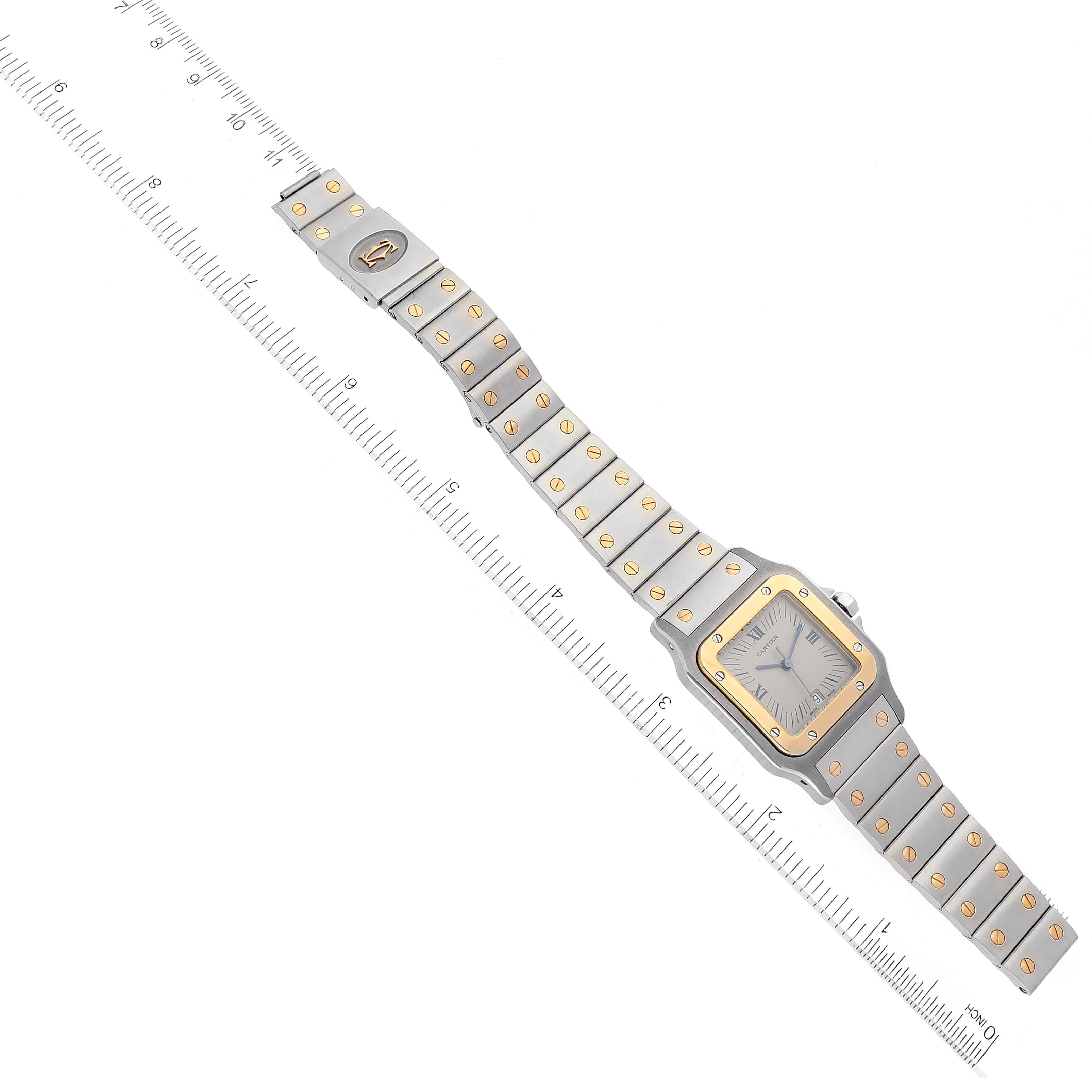 The image shows a Cartier Santos 187901 Men's Steel and Gold (two tone) White Dial 187901 Men's Steel and Gold (two tone) White Dial watch laid flat, with the entire watch face and bracelet visible alongside a ruler for measurement.