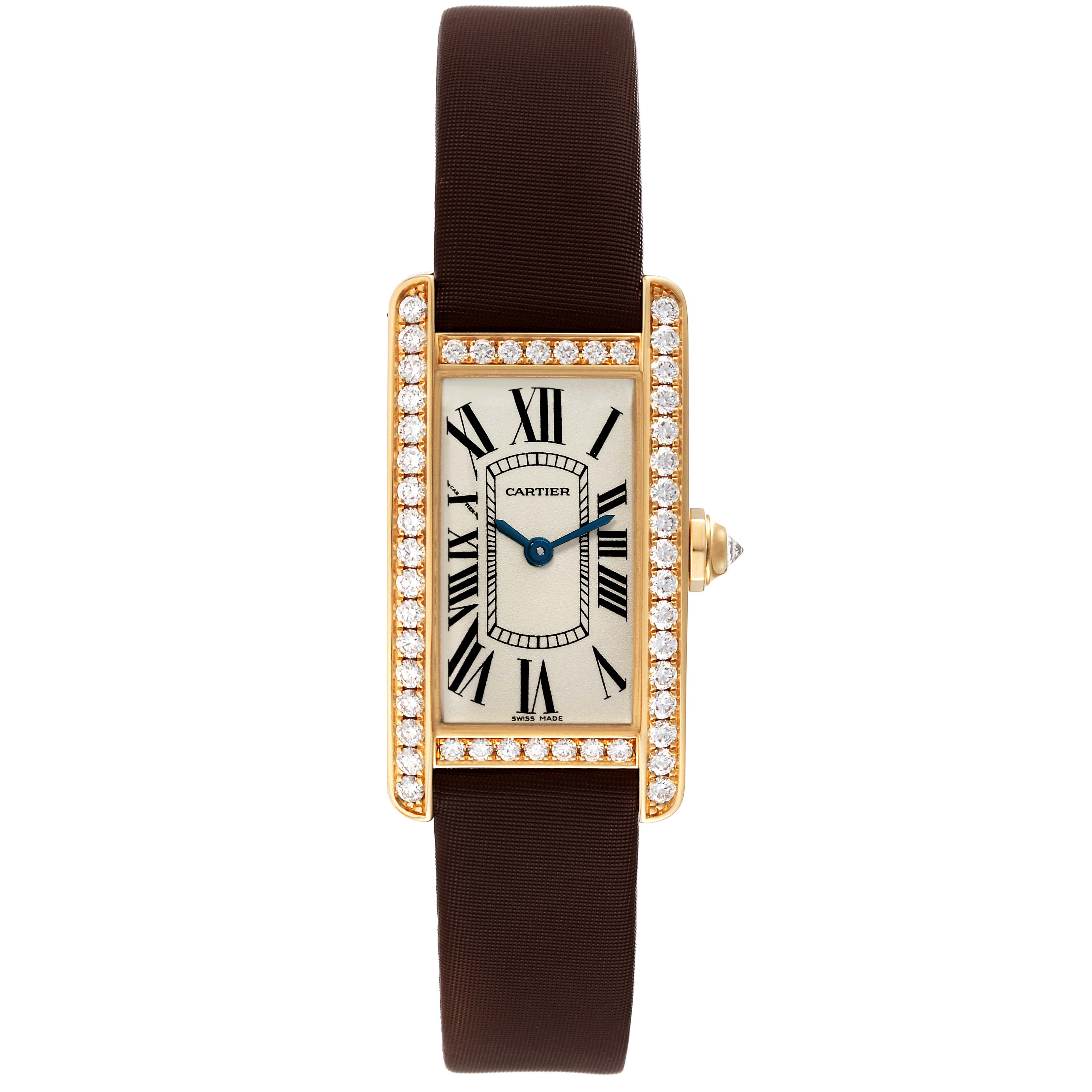 The image shows a top-down view of the Cartier Tank Americaine WB707231 Women's Yellow Gold Silver Dial WB707231 Women's Yellow Gold Silver Dial watch, highlighting its rectangular face, Roman numeral dial, diamond bezel, and brown strap.