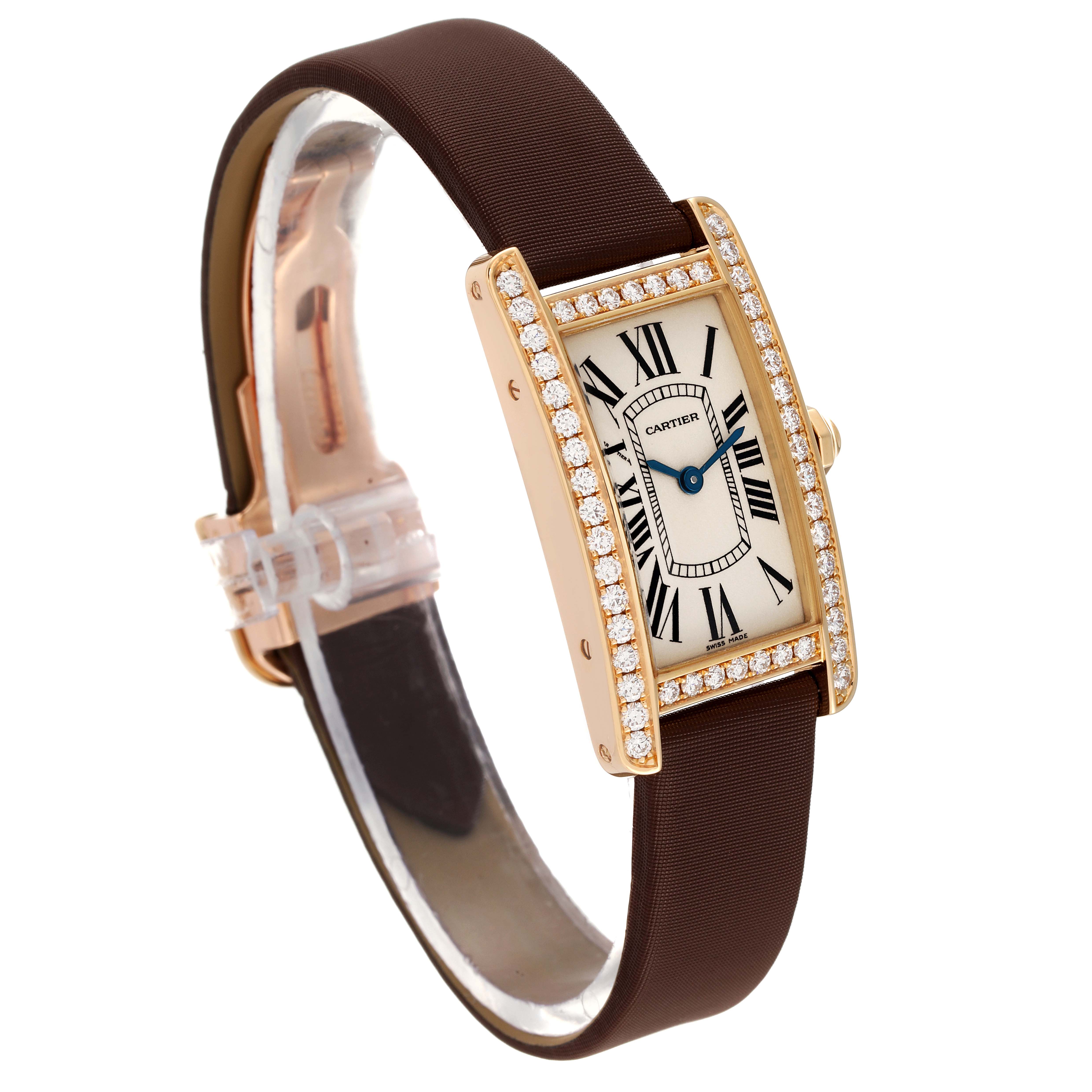 The Cartier Tank Americaine WB707231 Women's Yellow Gold Silver Dial WB707231 Women's Yellow Gold Silver Dial watch is shown at a slight angle, displaying its rectangular face, diamond-set bezel, and brown strap.