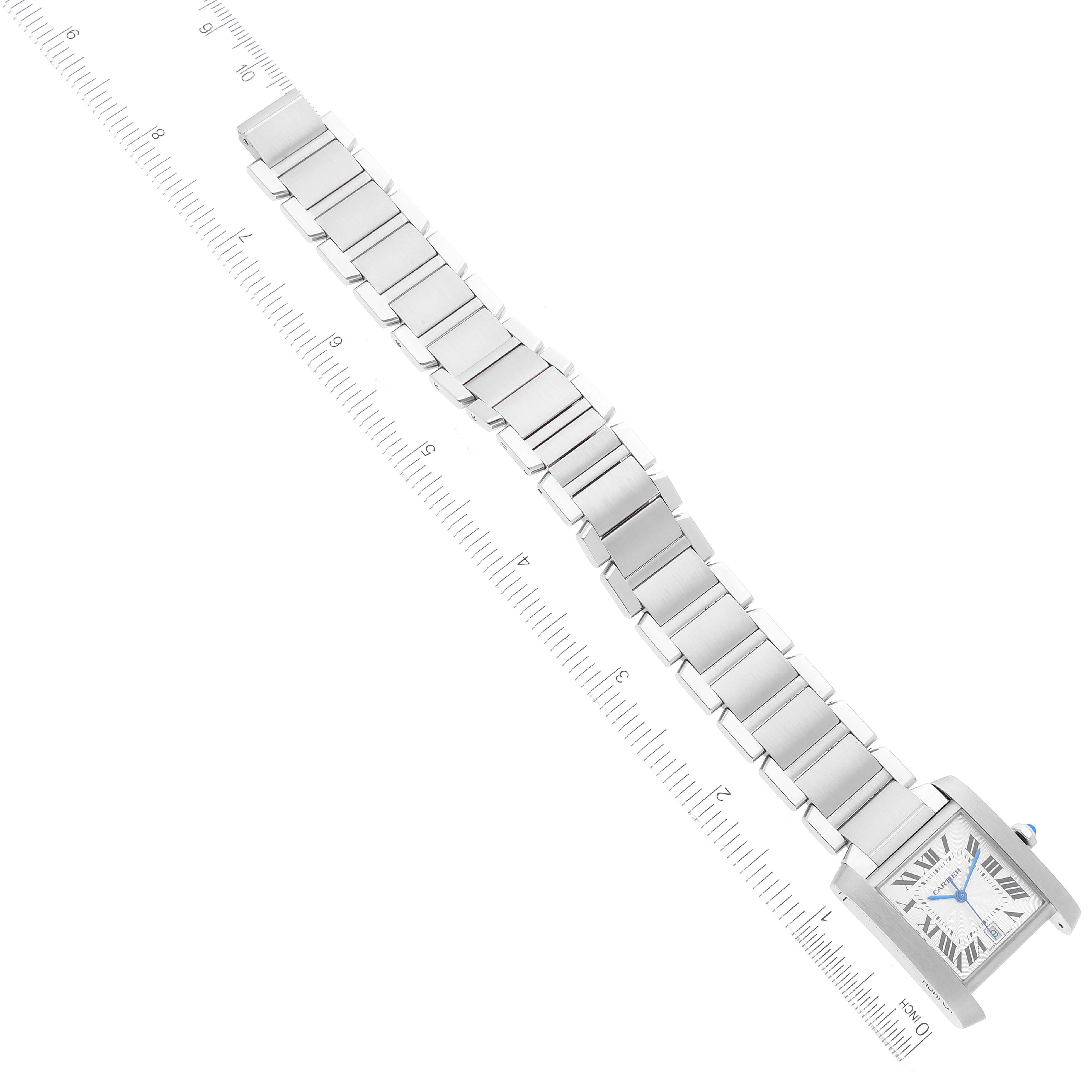 The image shows an overhead view of a Cartier Tank Francaise W51002Q3 Men's Stainless Steel Silver Dial W51002Q3 Men's Stainless Steel Silver Dial watch with a ruler indicating the length of the bracelet.