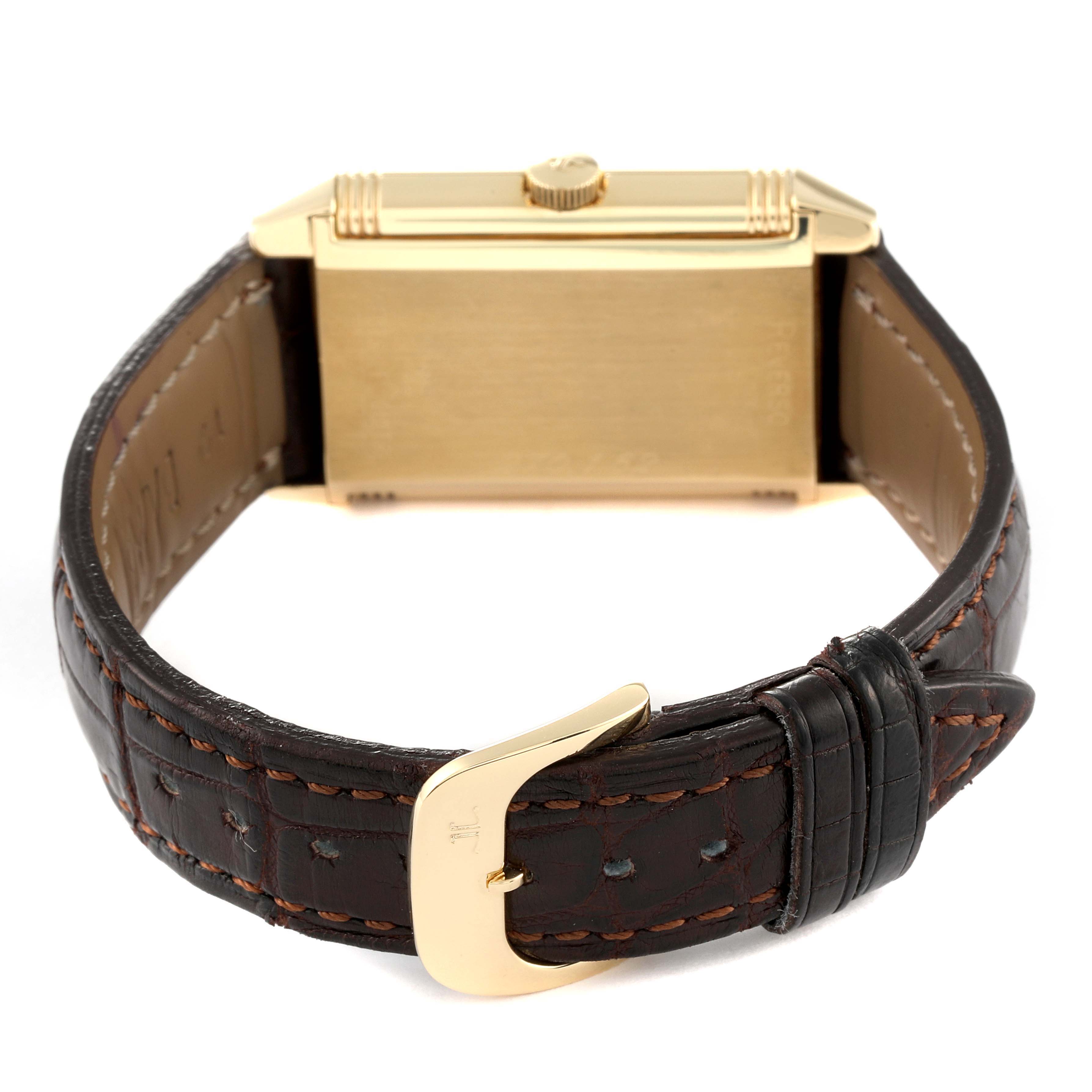 This Reverso model by Jaeger LeCoultre is shown from the back, displaying its case and brown leather strap with a gold clasp.