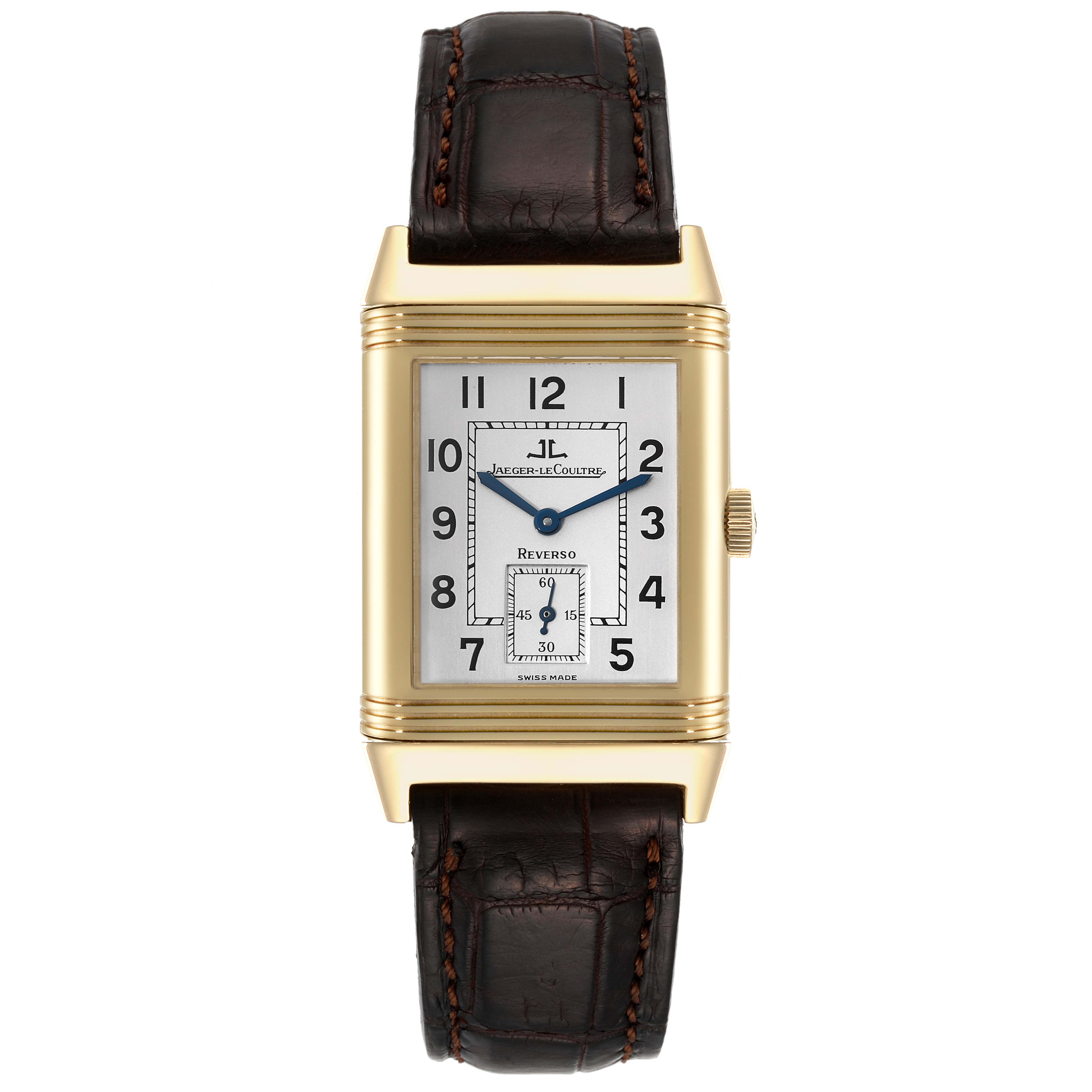 The image shows a front view of a Jaeger-LeCoultre Reverso watch, featuring its face, hands, crown, and leather strap.