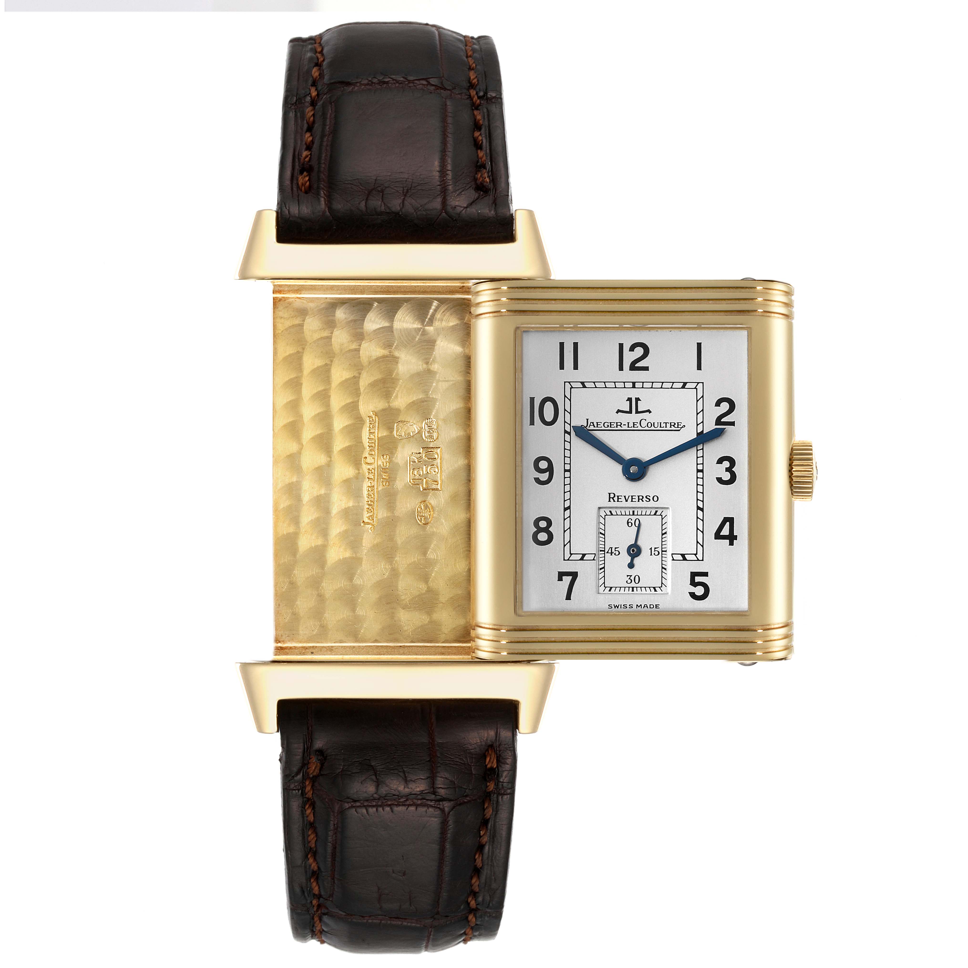 The Jaeger LeCoultre Reverso 270.1.62 Men's Yellow Gold Silver Dial 270.1.62 Men's Yellow Gold Silver Dial watch is angled to show both its face and its engraved inner case with the strap visible.