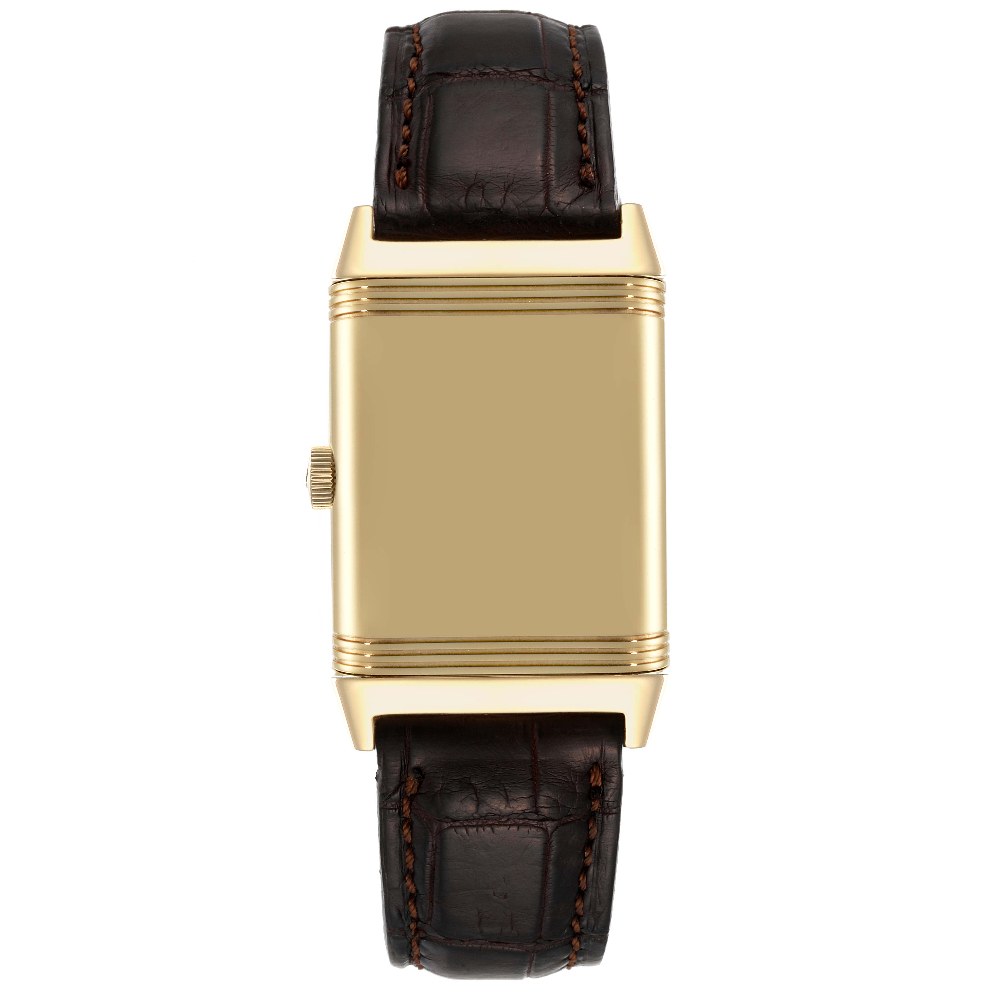 This image shows a top view of the Jaeger-LeCoultre Reverso watch with a gold case and brown leather strap, highlighting the side crown.