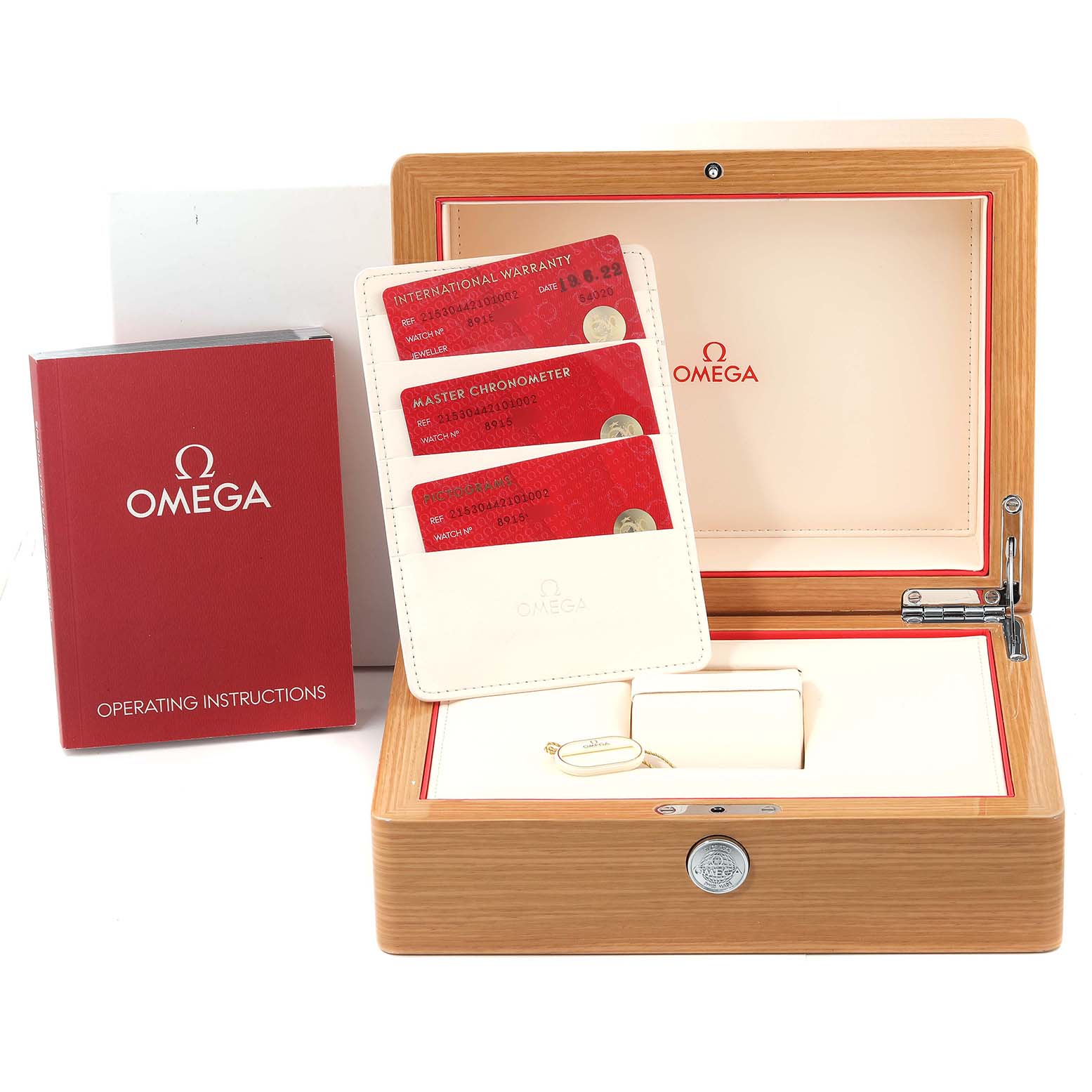 The image shows the packaging, warranty cards, tags, and operating instructions for an Omega Planet Ocean 215.30.44.21.01.002 Men
s Stainless Steel Black Dial 215.30.44.21.01.002 Men
s Stainless Steel Black Dial model watch.