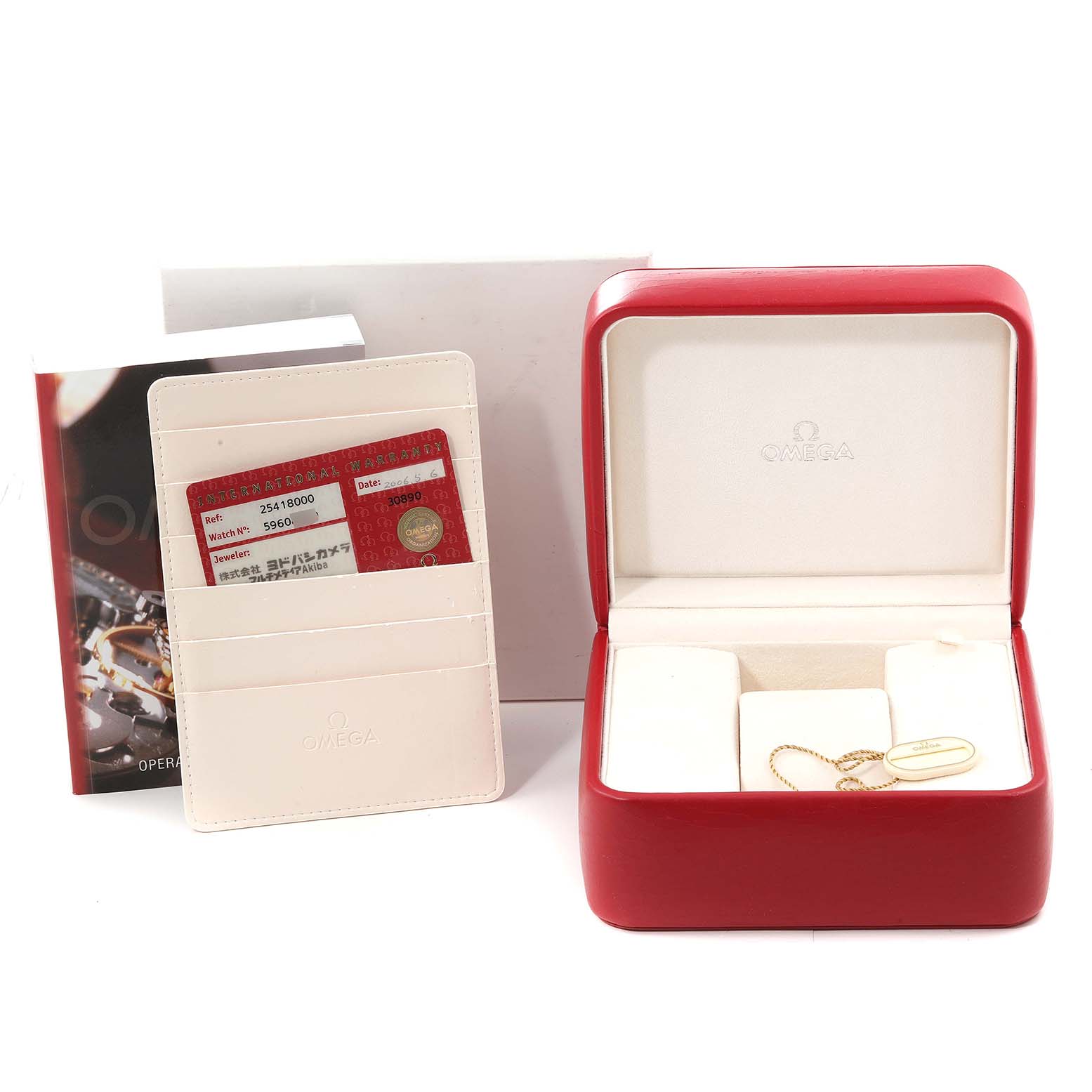 The image shows accessories for the Omega Seamaster 2541.80.00 Men's Stainless Steel Blue Dial 2541.80.00 Men's Stainless Steel Blue Dial, including a red watch box, warranty cards, and an instruction manual.