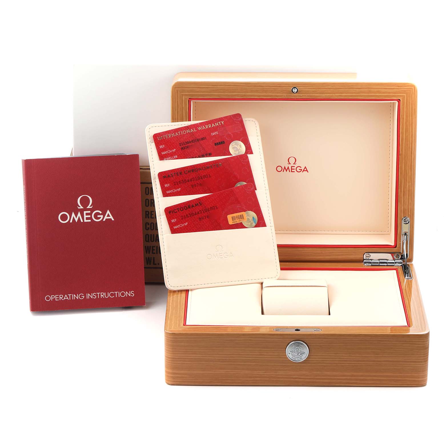 The image shows the Omega Planet Ocean model 215.30.44.21.01.001 packaging, including the box, warranty cards, and operating instructions, viewed from the front.