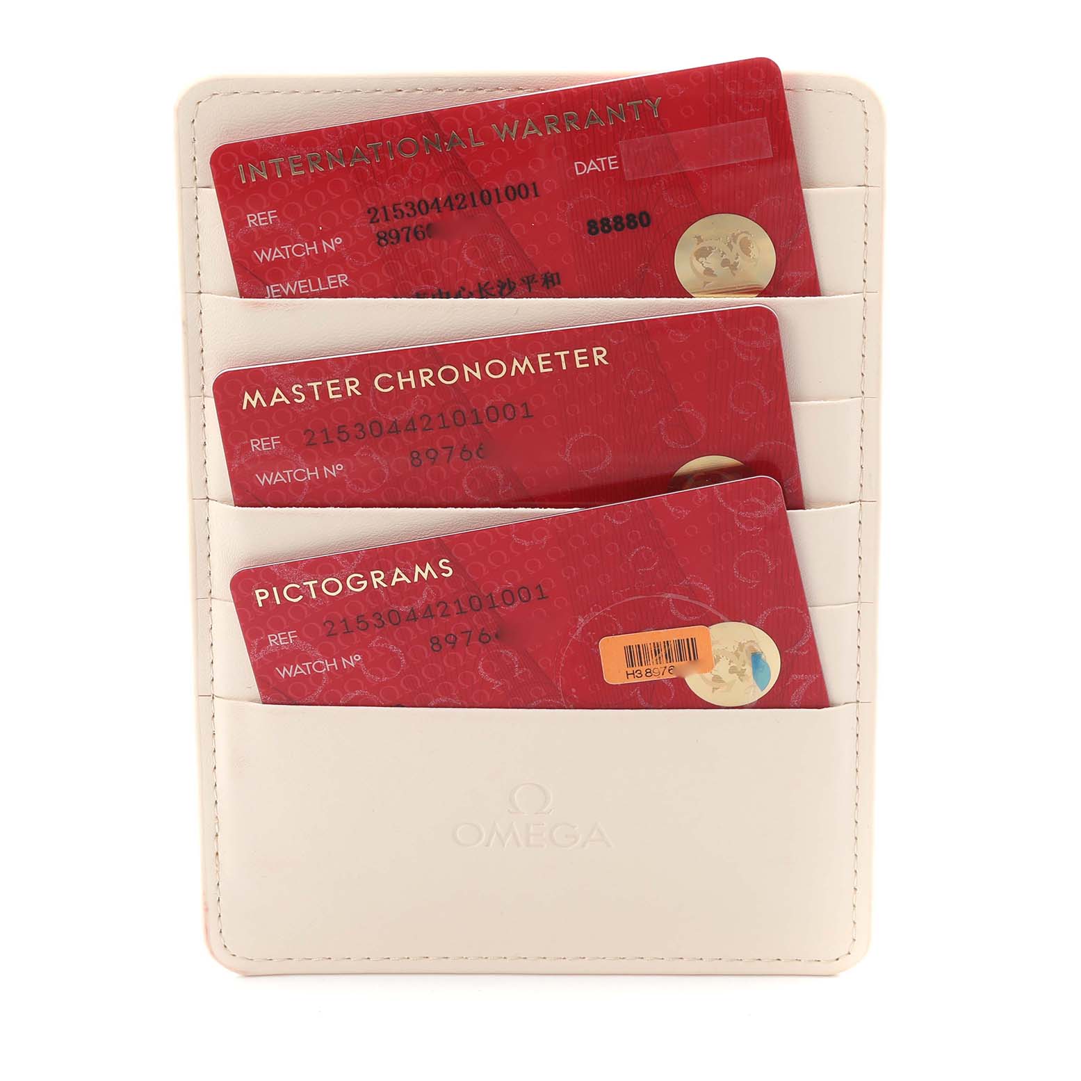 The image shows Omega Planet Ocean model 215.30.44.21.01.001 documentation cards in a holder, including warranty, chronometer, and pictograms.