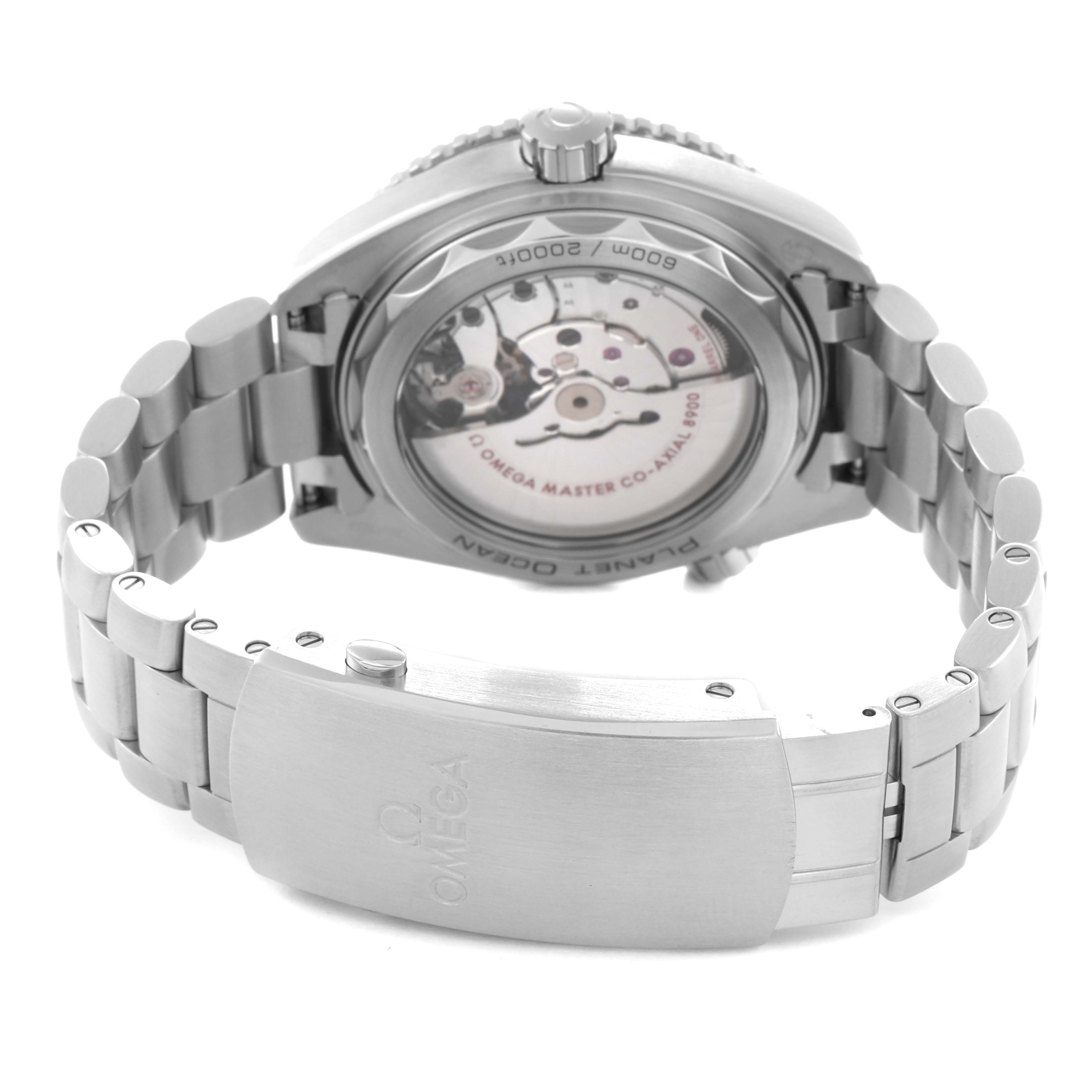 The image shows a rear angle of the Omega Planet Ocean model 215.30.44.21.01.001, highlighting its transparent case back and metal bracelet with the clasp.