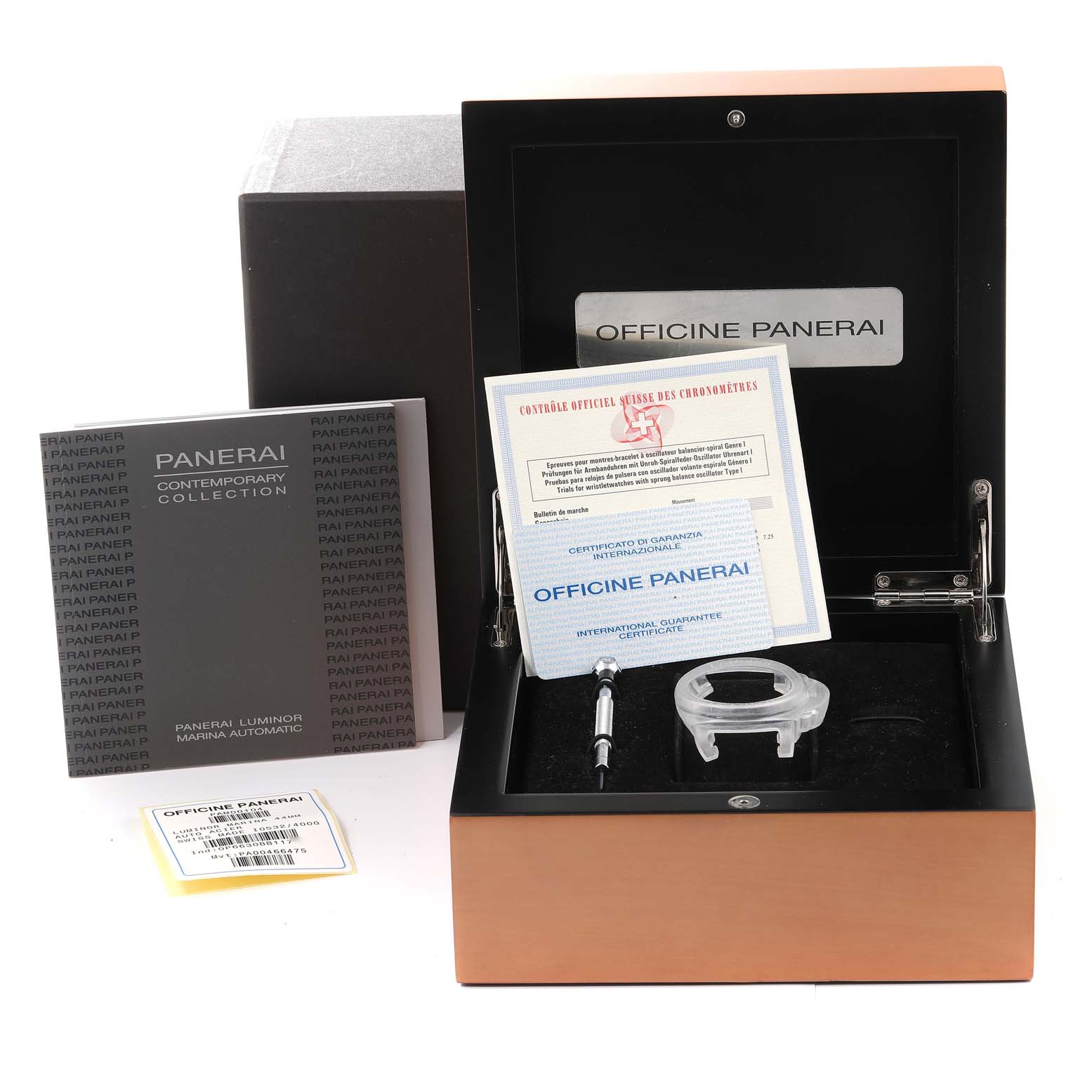 The image shows the box and accessories for a Panerai Luminor PAM00104 Men
s Stainless Steel Black Dial PAM00104 Men
s Stainless Steel Black Dial watch, including manuals, a guarantee certificate, a tool, and protective casing parts.