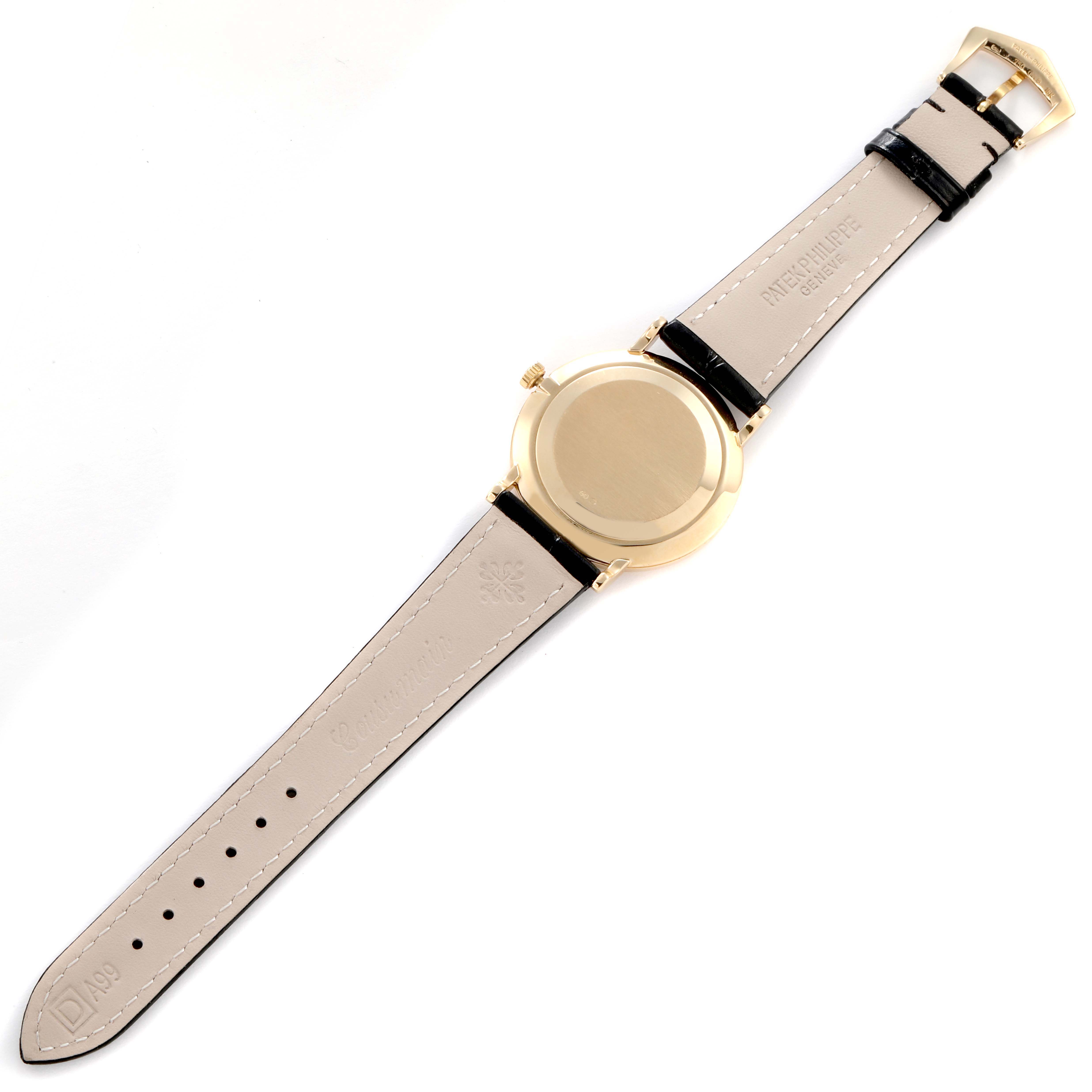 The image shows the back view of a Patek Philippe Calatrava model 5022J-001 men's watch, featuring its case back, leather strap, and buckle.