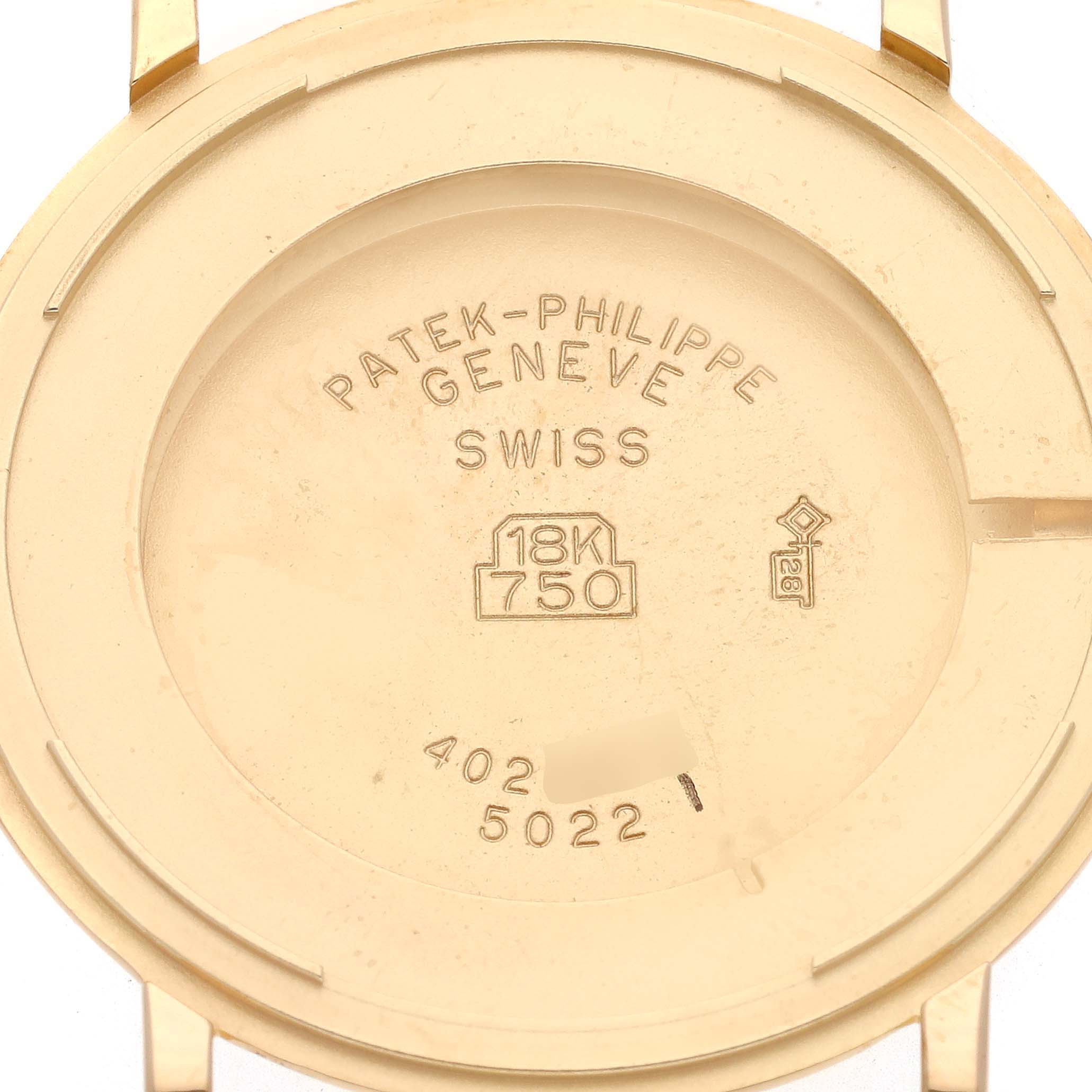 The image shows the back case of a Patek Philippe Calatrava model 5022J-001 men's watch, displaying markings like "18K 750" and "SWISS."