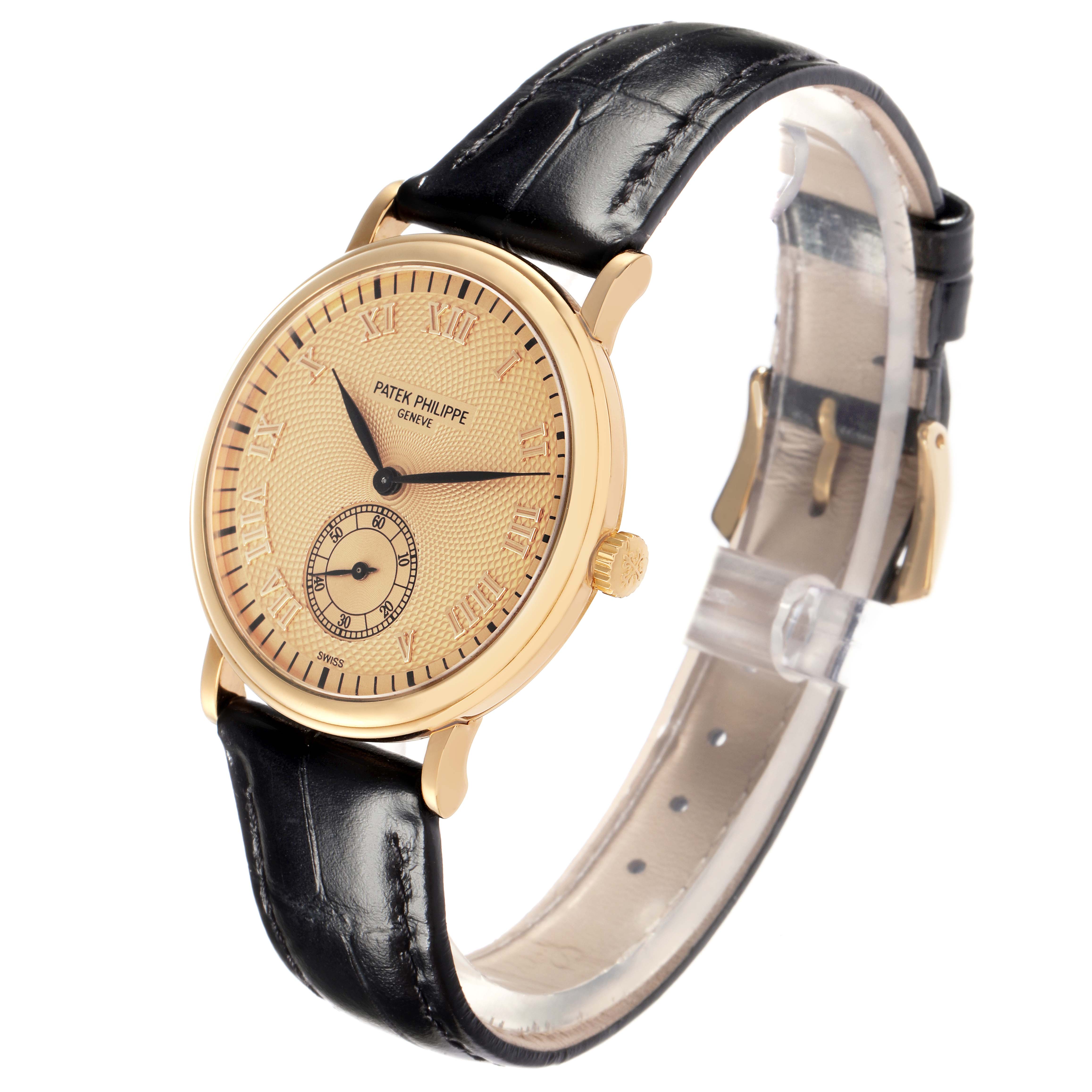 The Patek Philippe Calatrava model 5022J-001 is shown at a three-quarter angle, highlighting its gold case, dial with Roman numerals, and black leather strap.