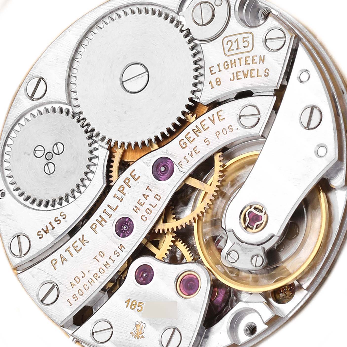The image shows the movement of the Patek Philippe Calatrava model 5022J-001 watch from a top-down angle, highlighting its gears and mechanical components.