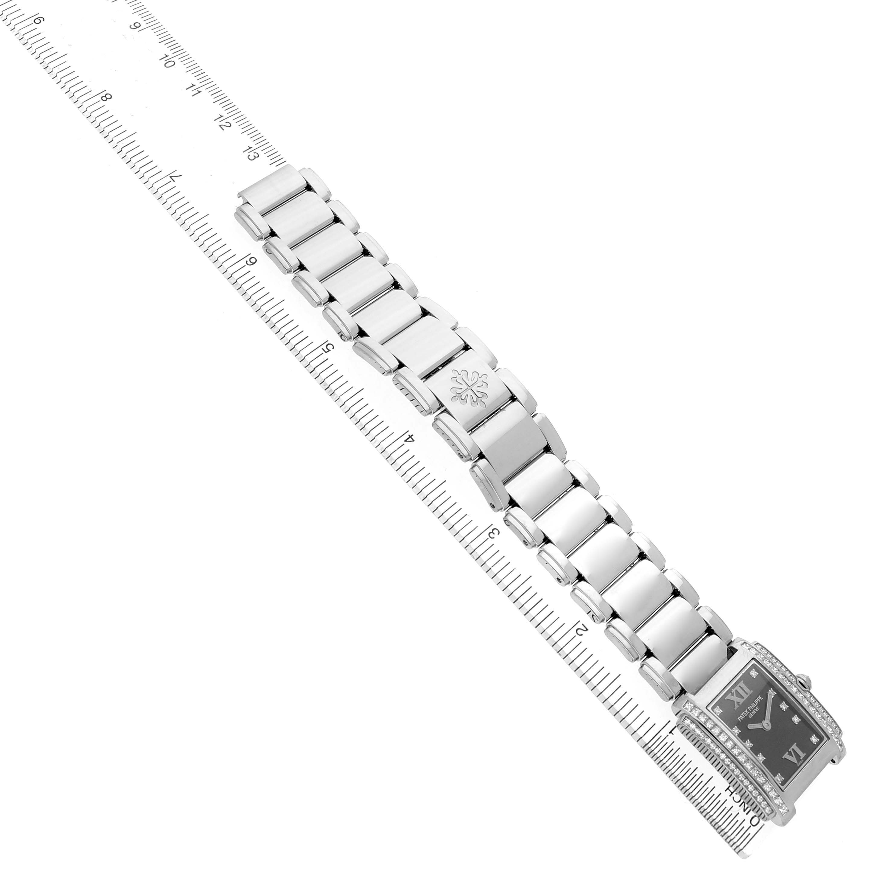 The Patek Philippe Twenty-4 4910/20G-001 Women's White Gold Black Dial watch is shown at a top-down angle, highlighting its bracelet and rectangular face.