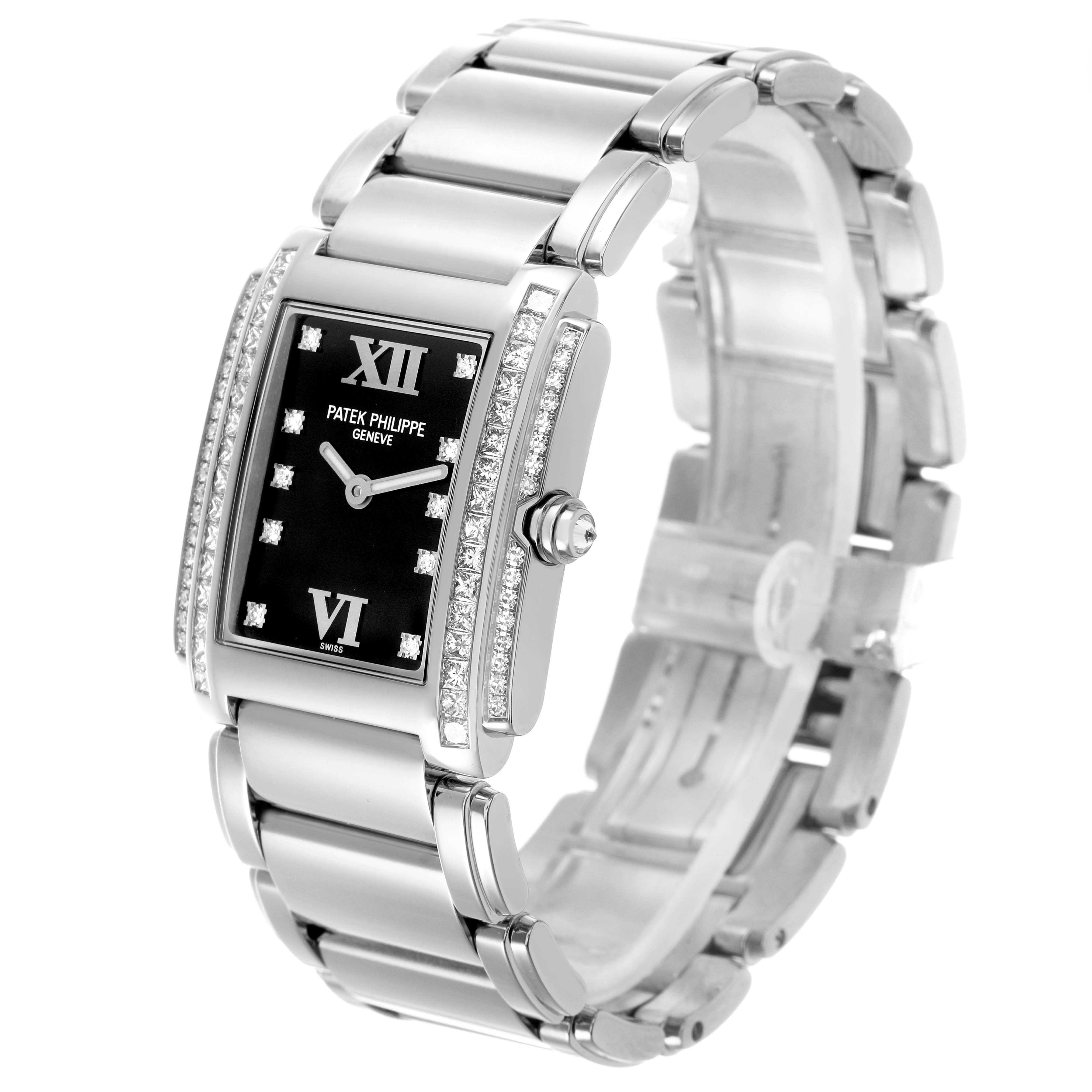 The Patek Philippe Twenty-4 4910/20G-001 Women's White Gold Black Dial watch is shown at an angled side view, highlighting its rectangular dial, diamond-set bezel, and stainless steel bracelet.