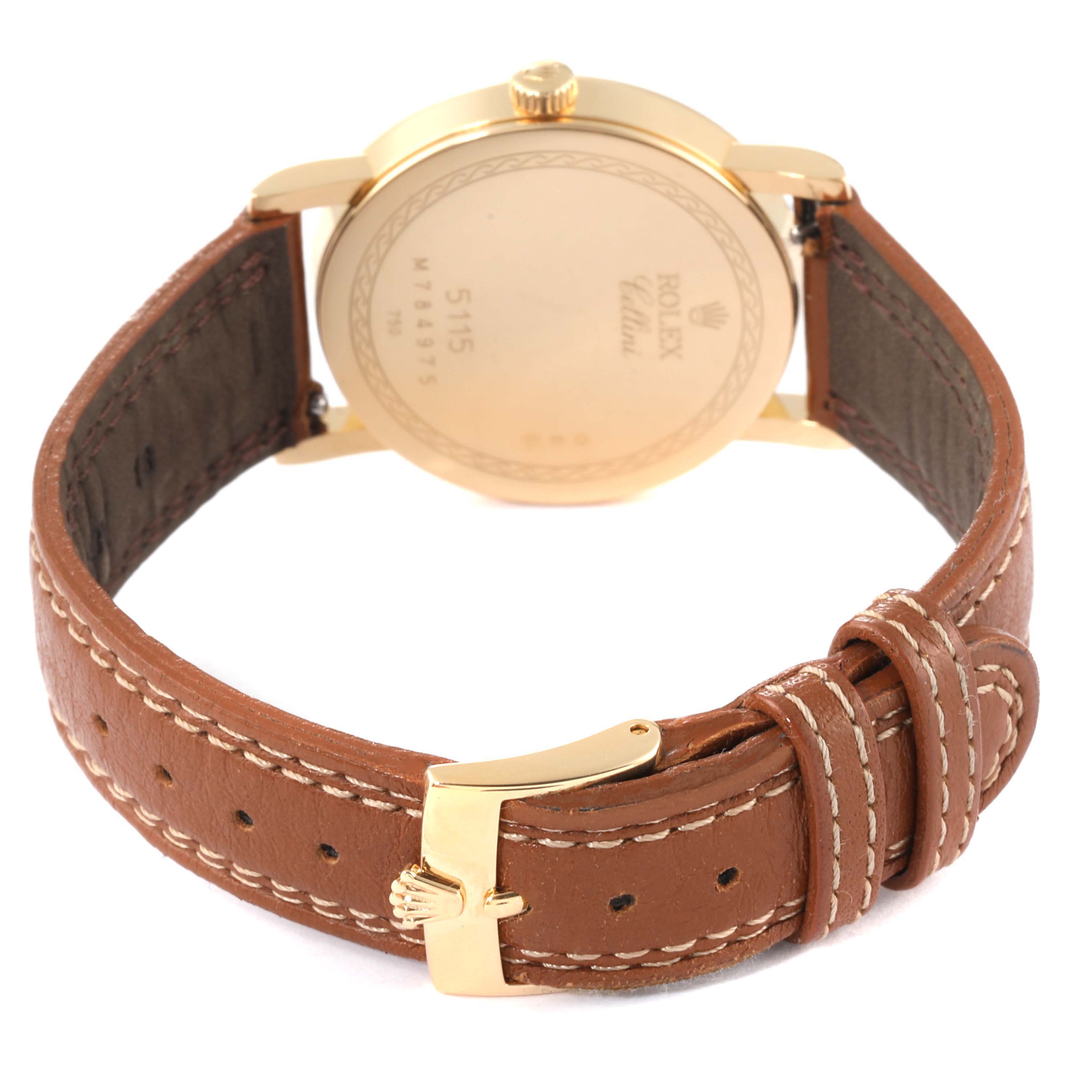 The image shows a Rolex Cellini 5115 Women's Yellow Gold Mother of Pearl Dial 5115 Women's Yellow Gold Mother of Pearl Dial watch from the back, focusing on the gold case, crown, and brown leather strap.