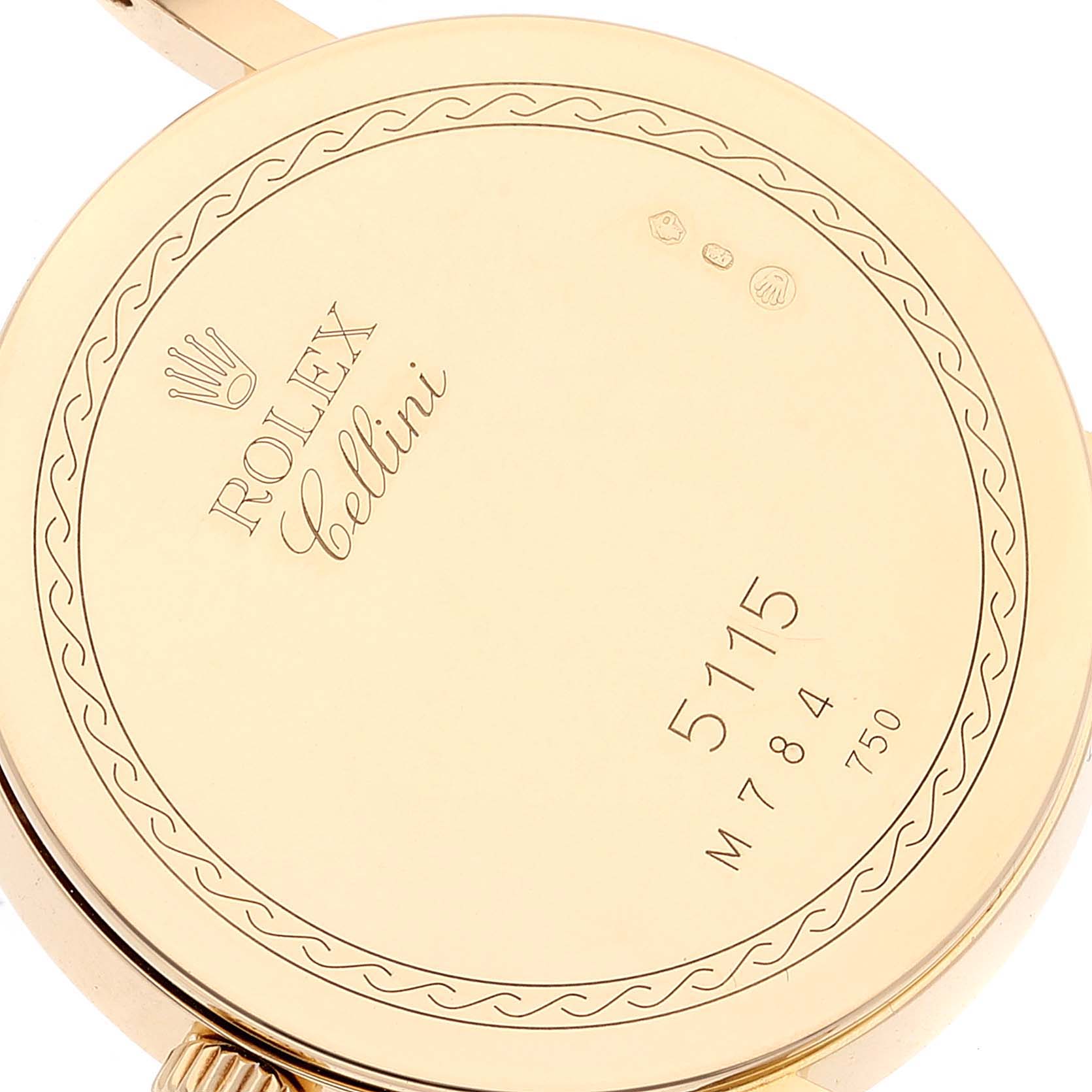 The image shows the back case of a Rolex Cellini 5115 Women's Yellow Gold Mother of Pearl Dial 5115 Women's Yellow Gold Mother of Pearl Dial watch, featuring engravings and hallmarks.