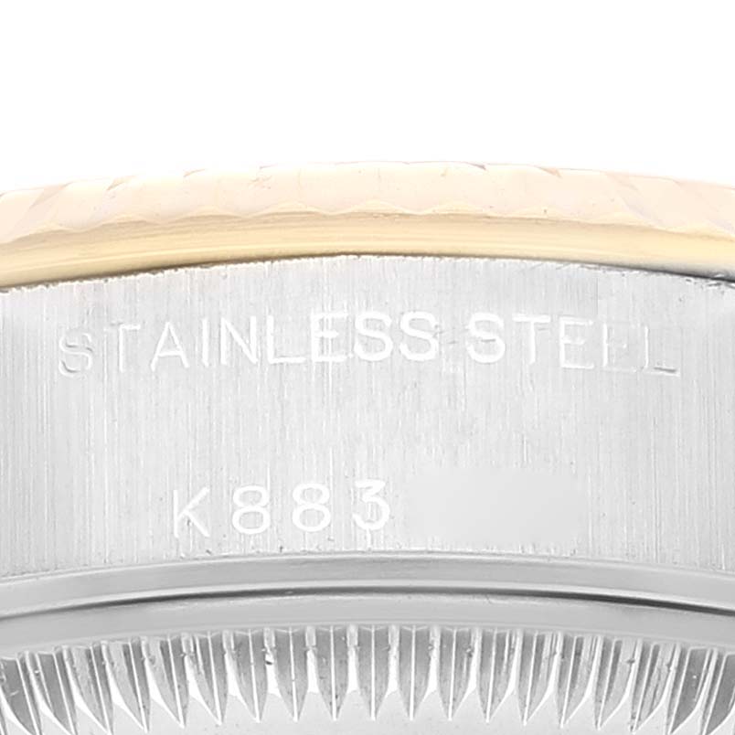 The image shows a close-up of the side of a Rolex Datejust 79173 Women's Steel and Gold (two tone) Grey Dial 79173 Women's Steel and Gold (two tone) Grey Dial watch, highlighting the stainless steel and serial numbers.