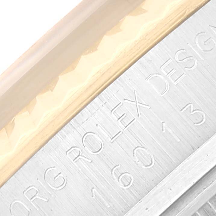 The image shows a close-up angle of the bezel and engraved edge of a Vintage Collection Rolex watch.