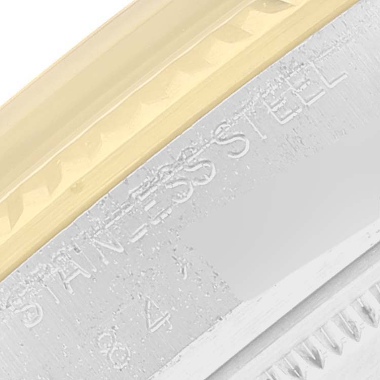 This image shows a partial close-up of the side of the case and bezel of a Rolex Vintage Collection 16013 Men's Steel and Gold (two tone) Champagne Dial 16013 Men's Steel and Gold (two tone) Champagne Dial watch, highlighting its stainless steel and gold accents.