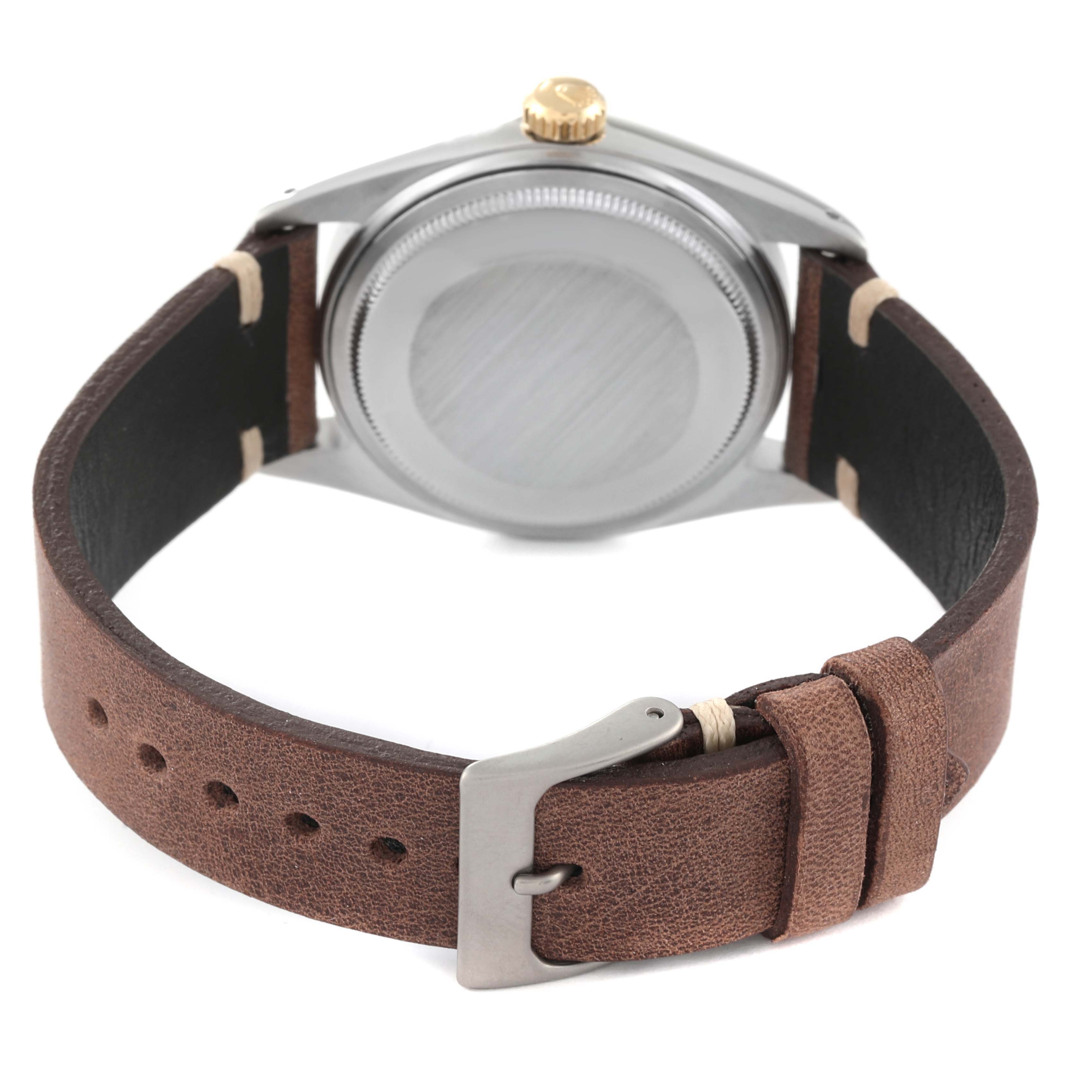 The image shows the back view of a Rolex Vintage Collection 16013 Men's Steel and Gold (two tone) Champagne Dial 16013 Men's Steel and Gold (two tone) Champagne Dial watch, highlighting the casing, crown, and brown leather strap.