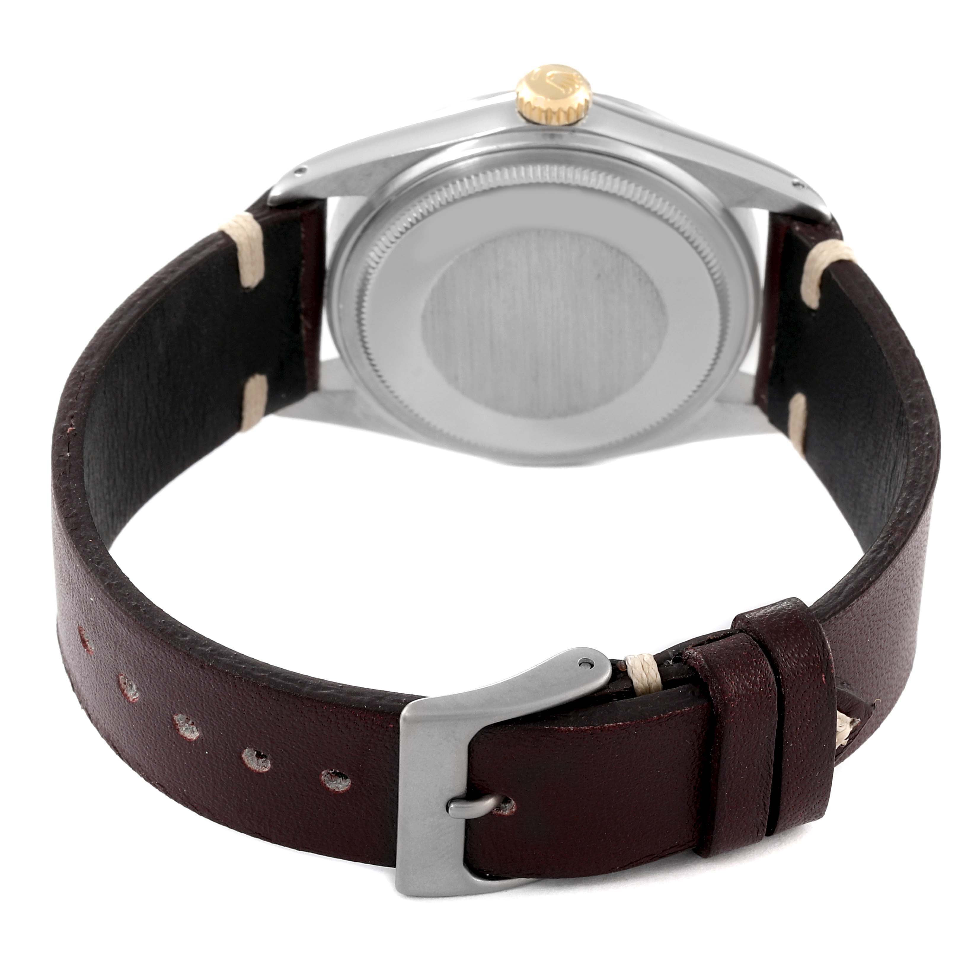 This image shows the back view of a Rolex Vintage Collection 16013 Men's Steel and Gold (two tone) Champagne Dial 16013 Men's Steel and Gold (two tone) Champagne Dial watch with a closed stainless steel case and leather strap.