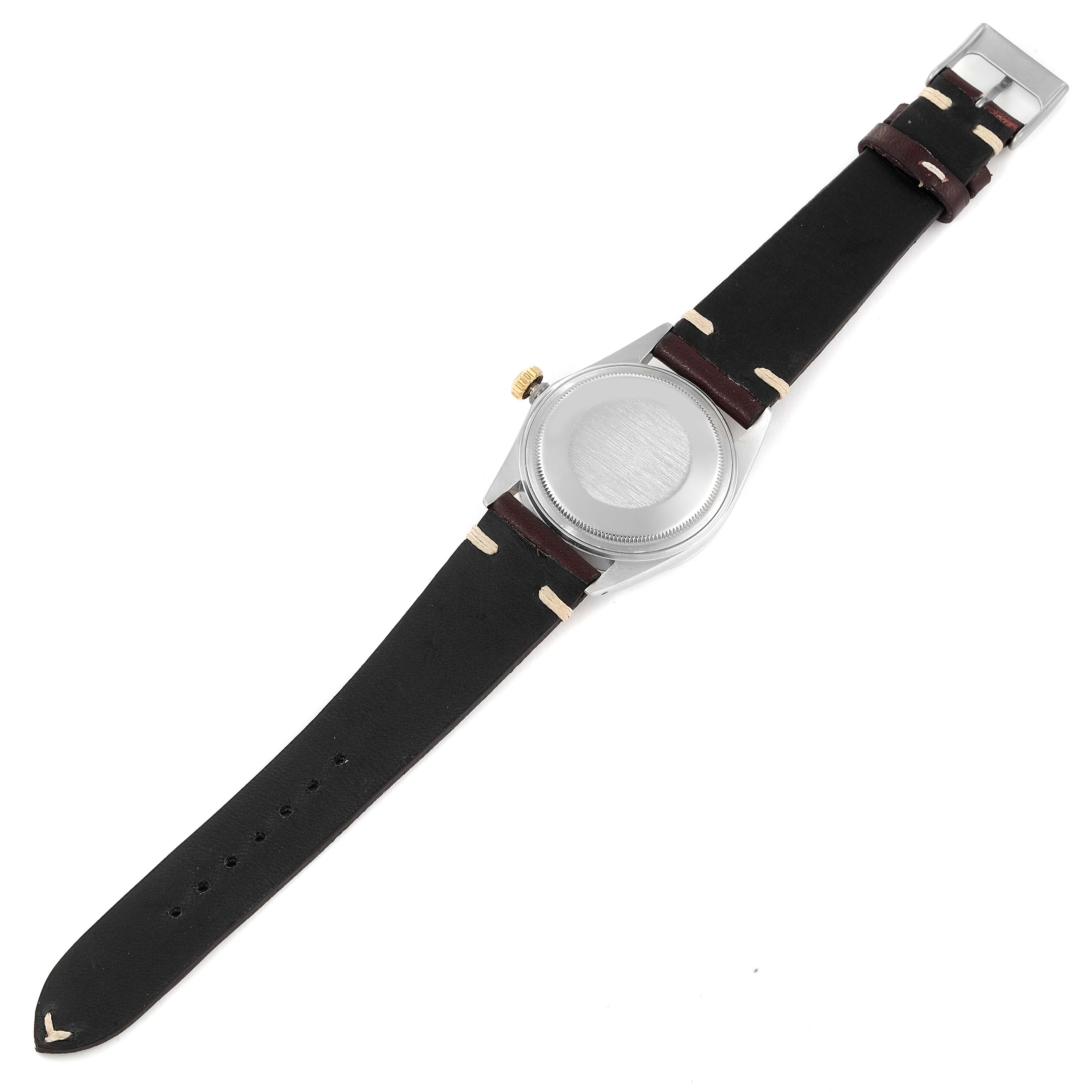 This image shows the back view of a Vintage Collection model by Rolex, featuring its stainless steel case and leather strap.