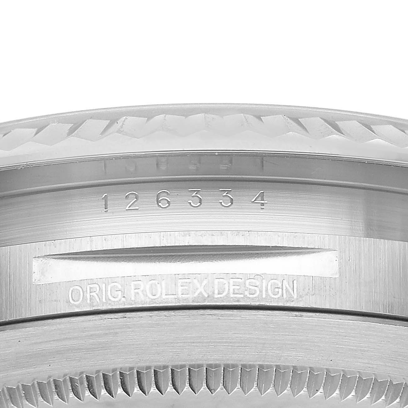 The image shows a close-up of the side and bezel edge of a Rolex Datejust 41 126334 Men's Stainless Steel Blue Dial, featuring engraved details.