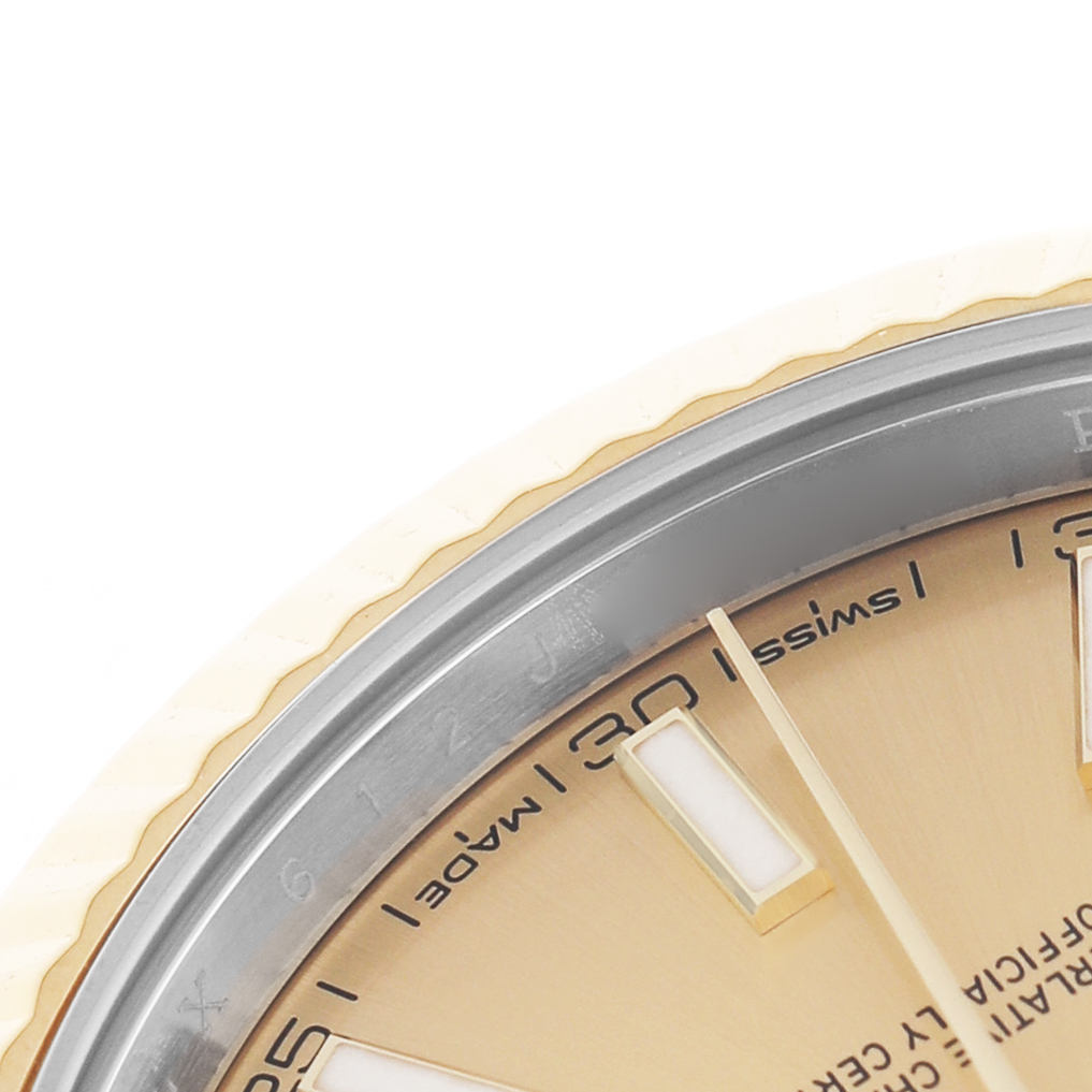 The image shows a close-up of the Rolex Datejust 41 126333 Men's Steel and Gold (two tone) Champagne Dial's dial and bezel, focusing on the numeral markers and part of the minute hand.