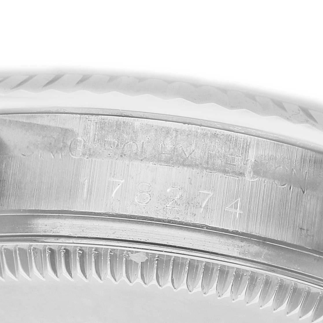 The image shows the side view of a Rolex Mid-Size 178274 Women's Stainless Steel Mother of Pearl Dial model, focusing on the case's serial number engraving.