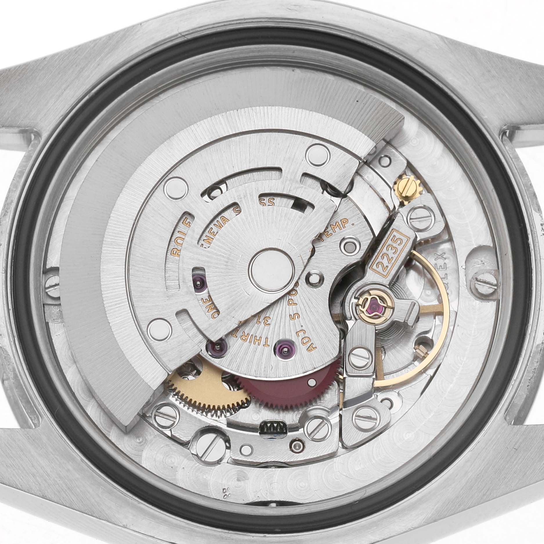 The image shows the movement of a Rolex Mid-Size 178274 Women's Stainless Steel Mother of Pearl Dial watch from a direct rear angle, highlighting gears and internal mechanisms.