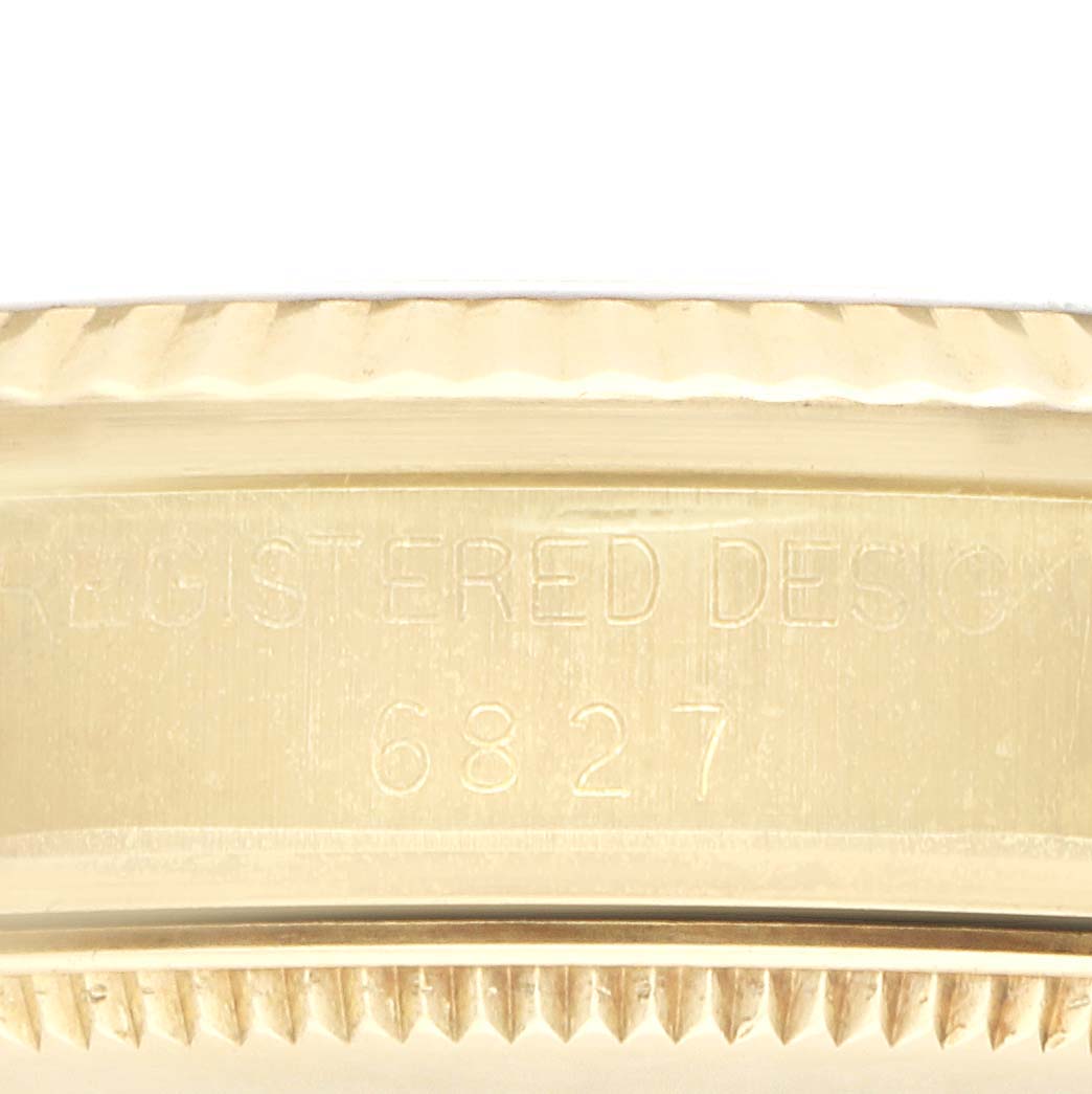 The image shows a close-up of the side of a Rolex Vintage Collection Men's watch, model number 6827, with engraved text on the case.
