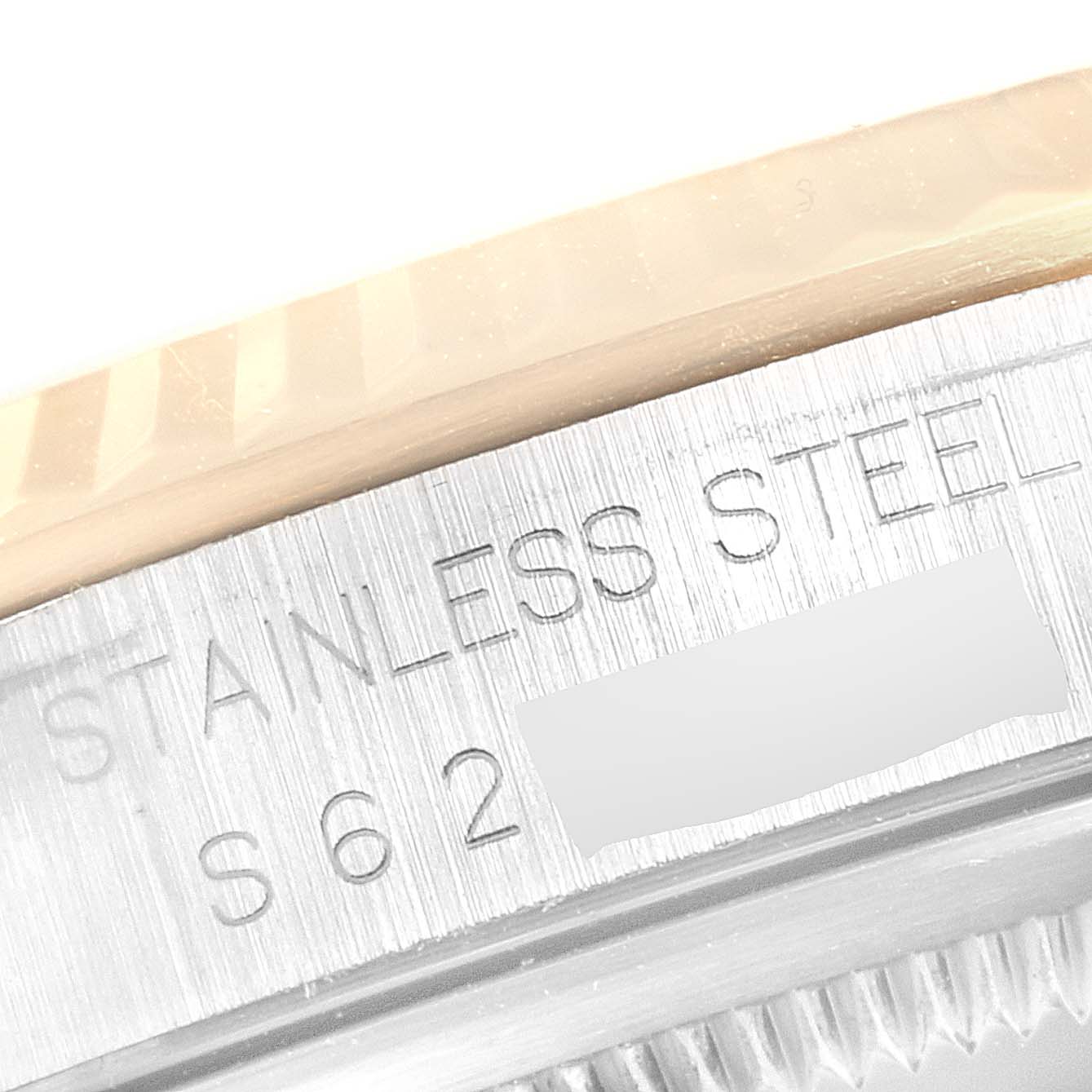 This close-up image shows the engravings of "Stainless Steel" and part of the serial or model number on a Rolex Datejust 16233 Men
s Steel and Gold (two tone) Champagne Dial 16233 Men
s Steel and Gold (two tone) Champagne Dial.