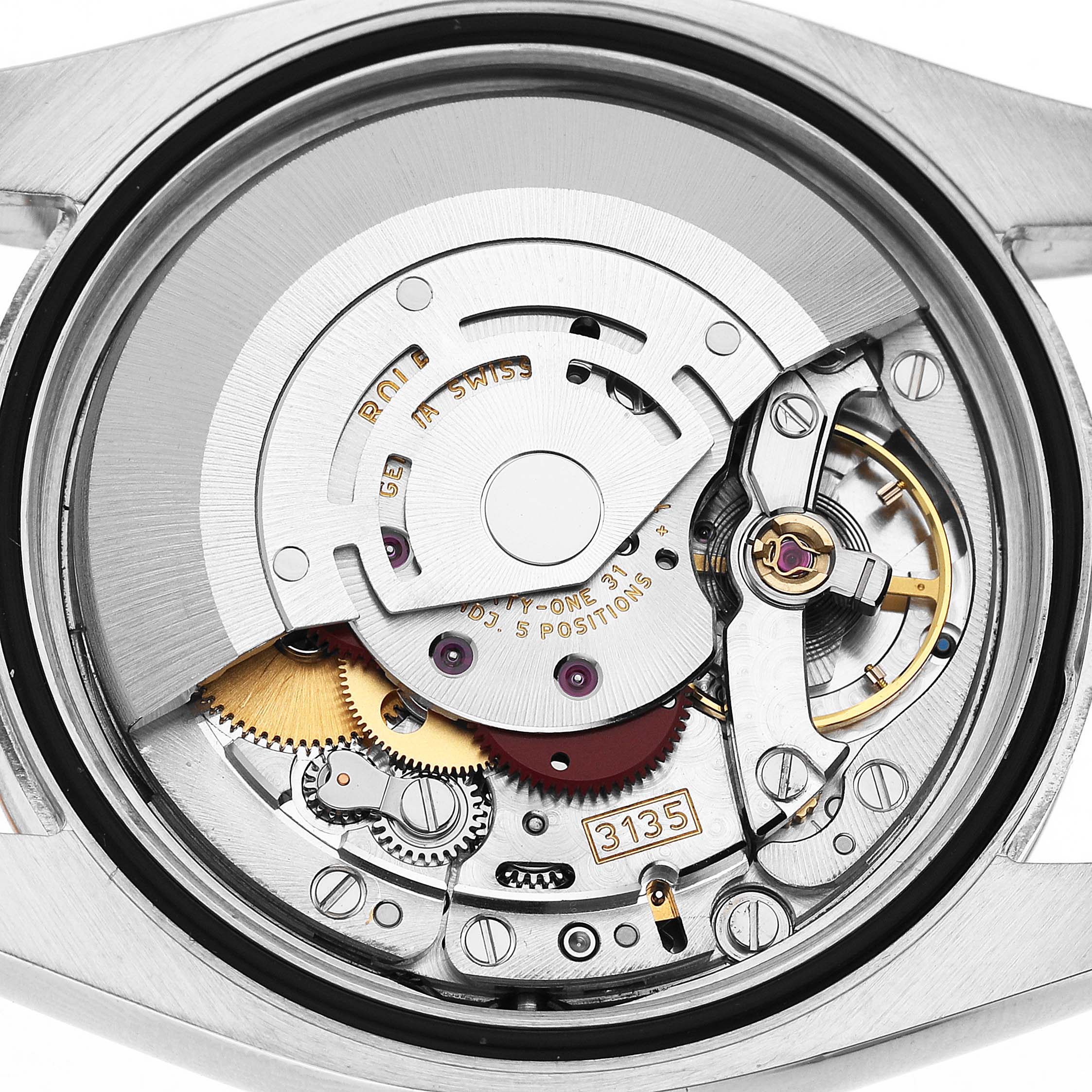 The image shows the movement of a Rolex Datejust 116201 Men's Steel and Gold (two tone) Silver Dial, including gears and the rotor, viewed from the case back.
