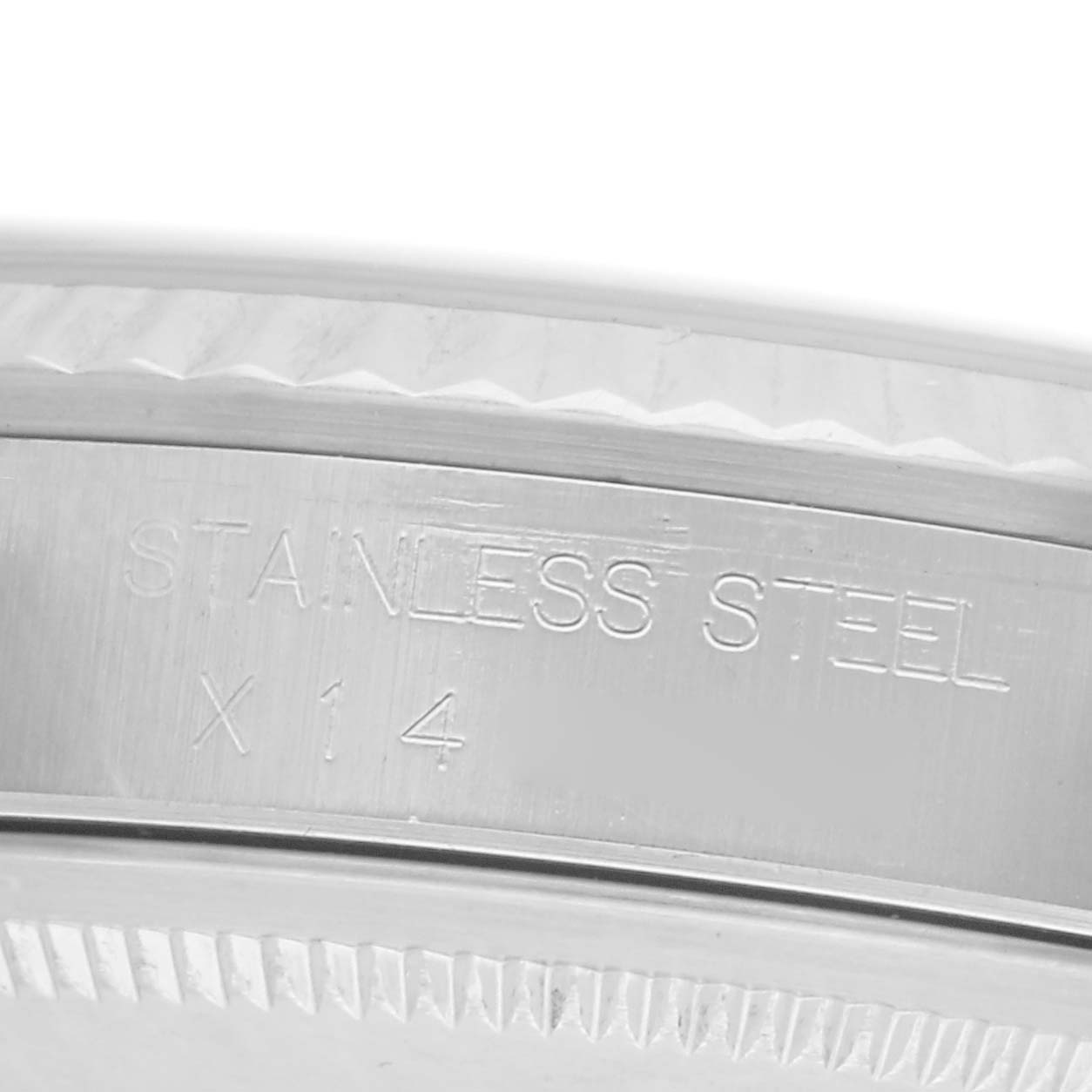 The image shows a close-up of the edge and side of a Rolex Datejust model number 16234, highlighting the stainless steel inscription.