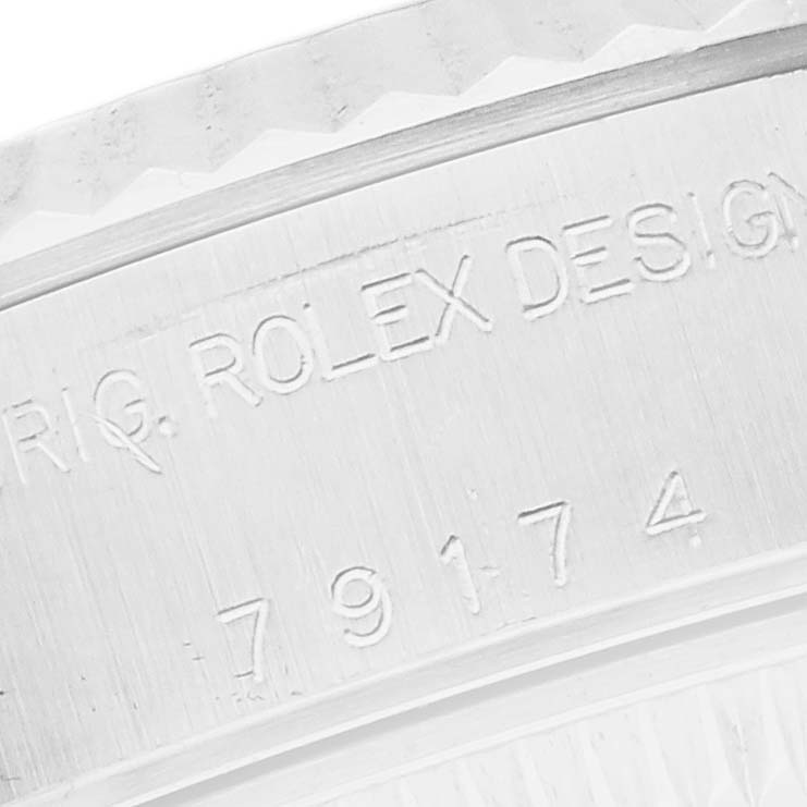 The image shows an engraved part of a Rolex Datejust watch, model number 79174, viewed closely to display the model details.