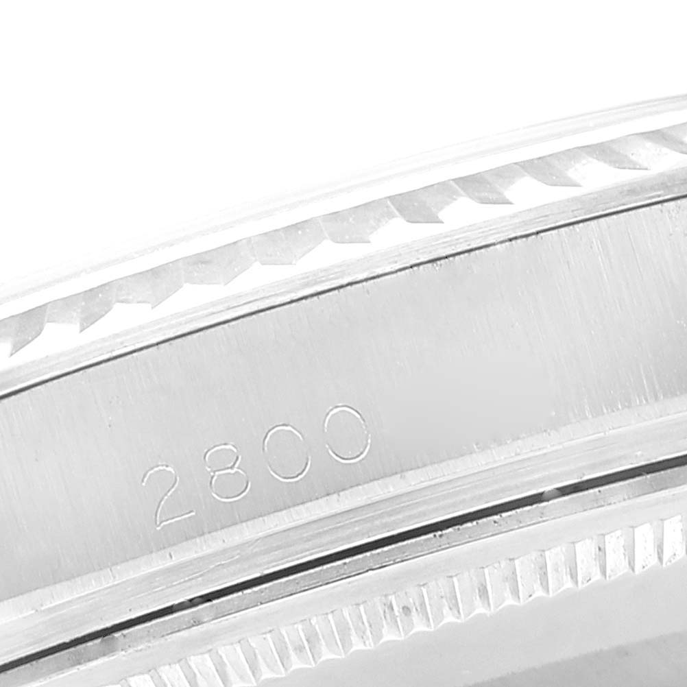 This image shows a close-up of the case and bezel of the Rolex Vintage Collection 1601 Men
s Stainless Steel Silver Dial 1601 Men
s Stainless Steel Silver Dial model with the number 2800 engraved.