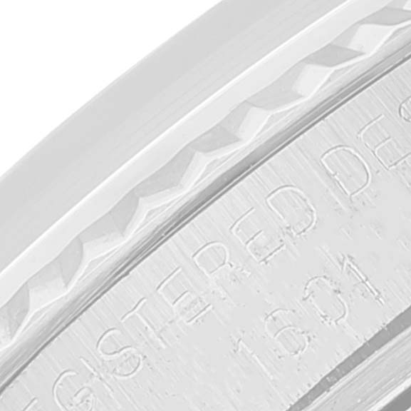 This close-up image shows part of the bezel and engraved inner rim of a Rolex Datejust 1601 Men's Stainless Steel Silver Dial 1601 Men's Stainless Steel Silver Dial watch.