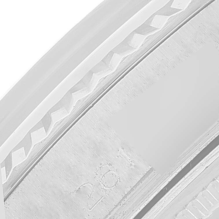 This close-up image shows the fluted bezel and faint engravings on the brushed surface of the Rolex Datejust 1601 Men's Stainless Steel Silver Dial 1601 Men's Stainless Steel Silver Dial watch.