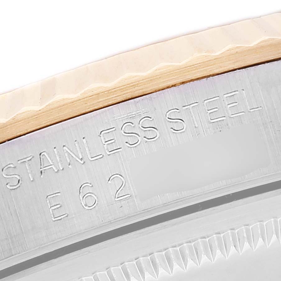 The image shows an extreme close-up of the edge engraving on the case back of a Rolex Datejust 16233 Men's Steel and Gold (two tone) Champagne Dial 16233 Men's Steel and Gold (two tone) Champagne Dial watch.