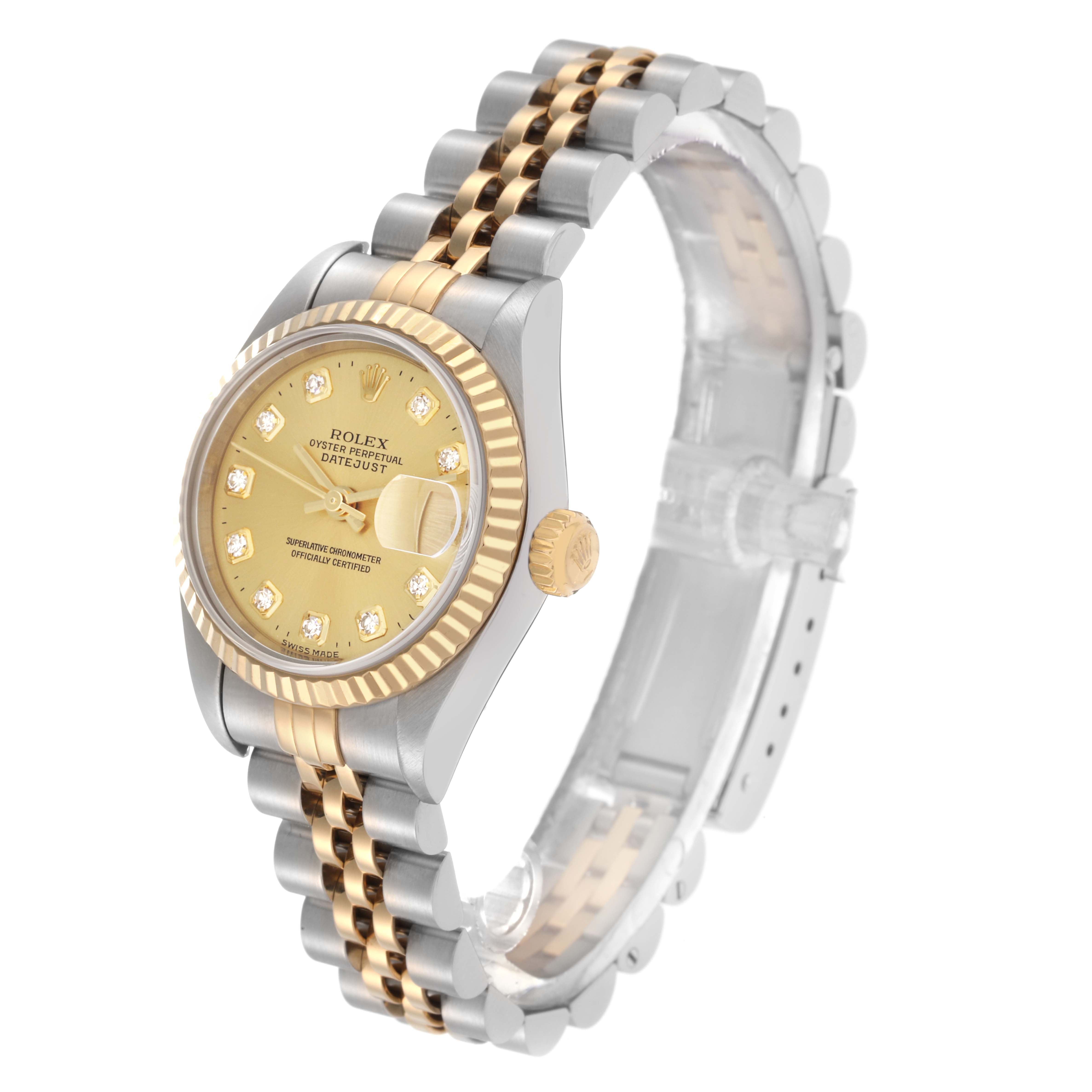 The image shows a Rolex Datejust model 79173 at a three-quarter angle, highlighting the gold dial, fluted bezel, and two-tone jubilee bracelet.