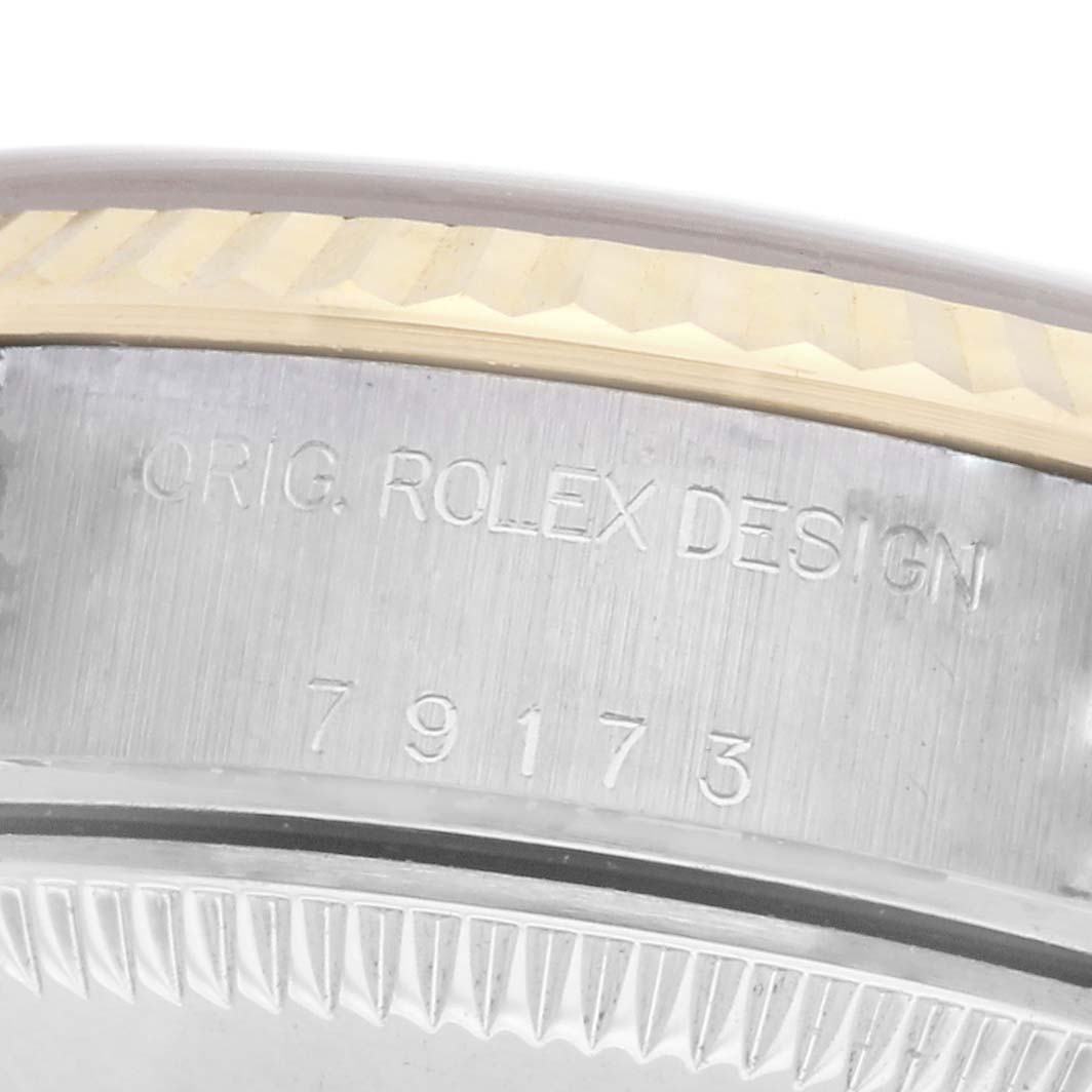 The image shows a close-up of the side and back of a Rolex Datejust model 79173, highlighting the engraved model number and bezel details.