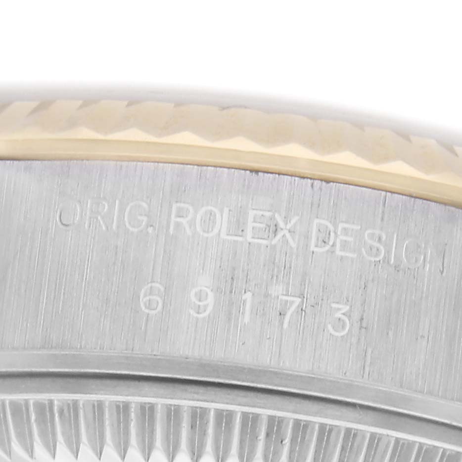 The image shows a close-up of the side casing of a Rolex Datejust, model number 69173, highlighting the engraving and the edge of the bezel.